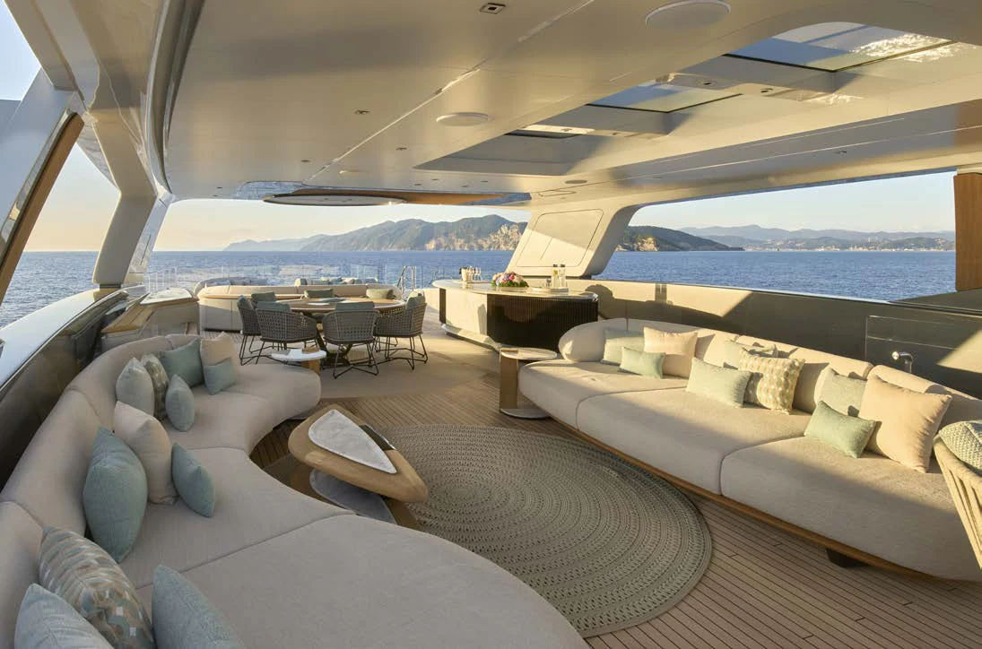 a living room with a couch and a large body of water aboard AWANDRA Yacht for Charter