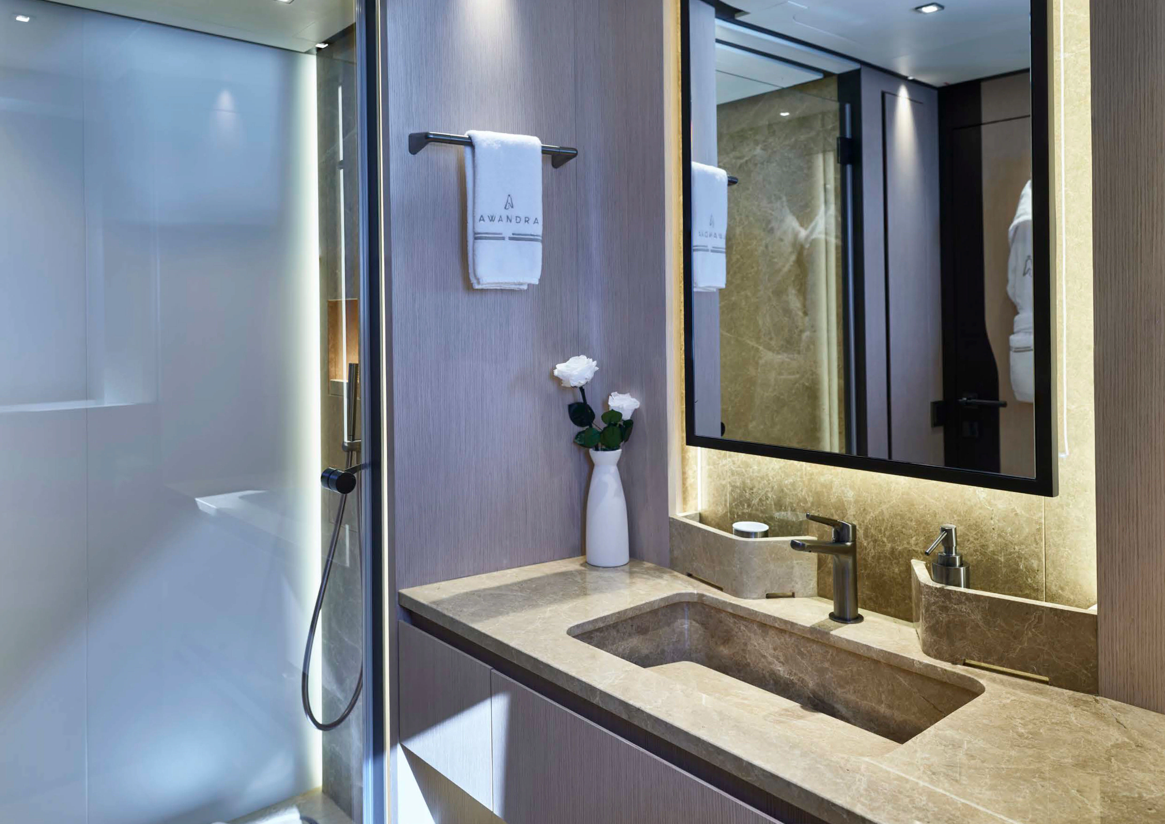 a bathroom with a sink and a mirror aboard AWANDRA Yacht for Charter