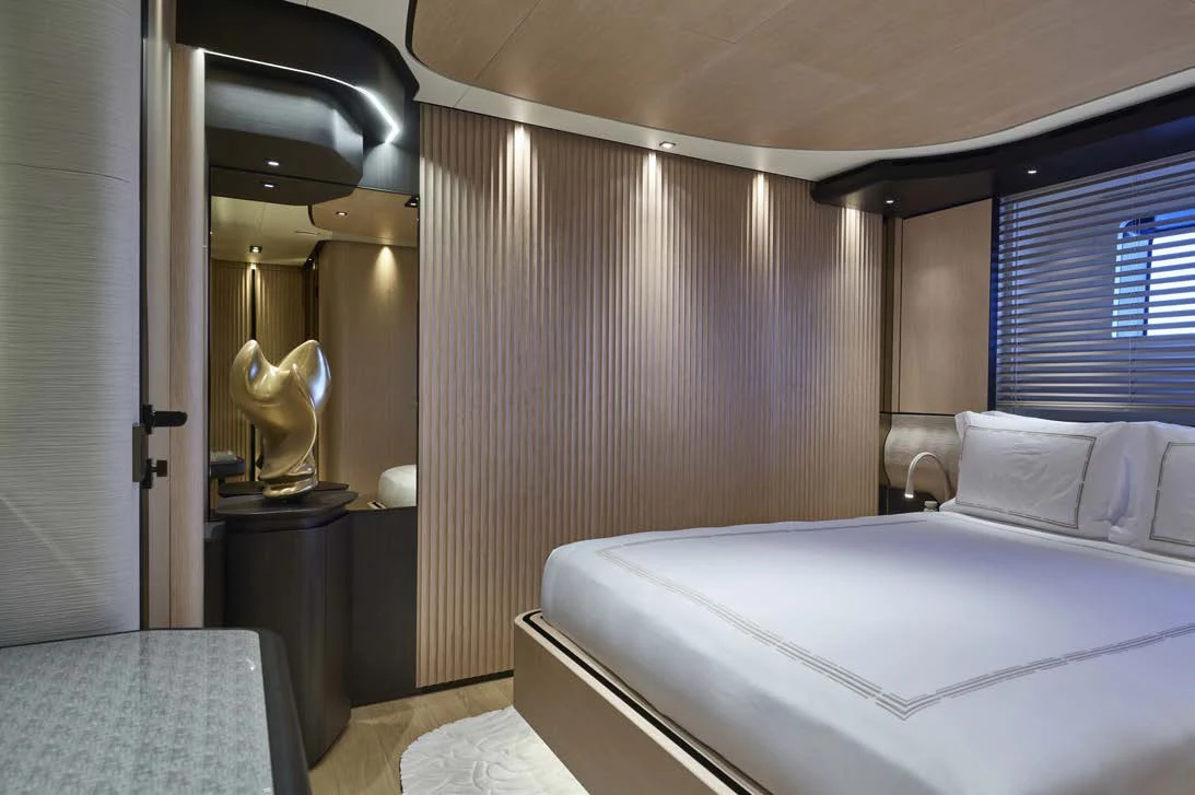 a bedroom with a bed and a mirror aboard AWANDRA Yacht for Charter
