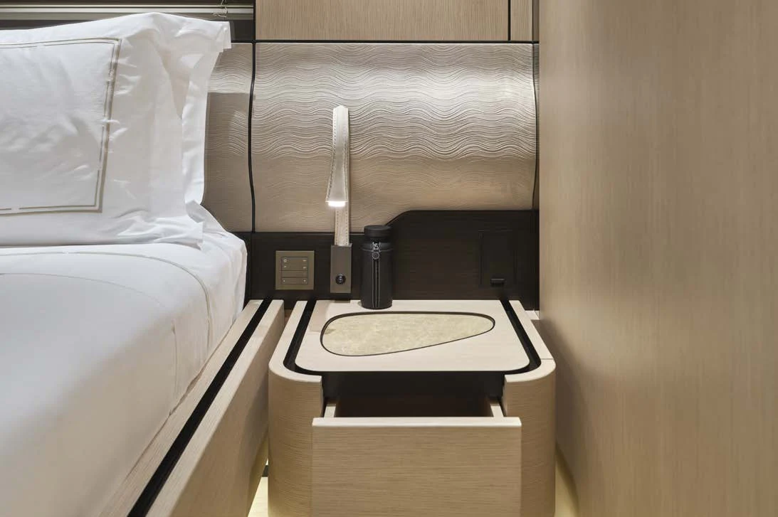 a bed with a black object on it aboard AWANDRA Yacht for Charter