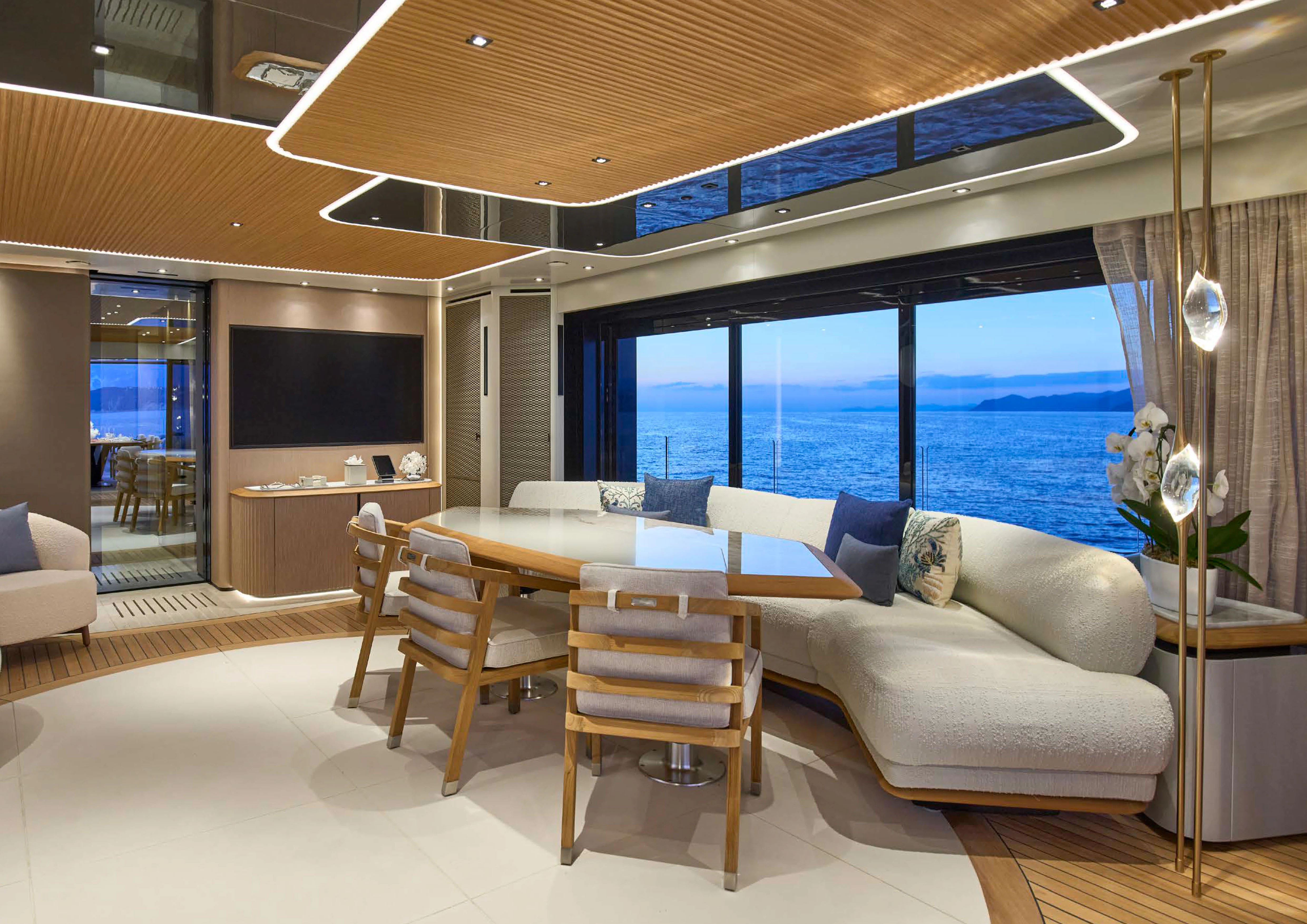 a living room with a large window aboard AWANDRA Yacht for Charter