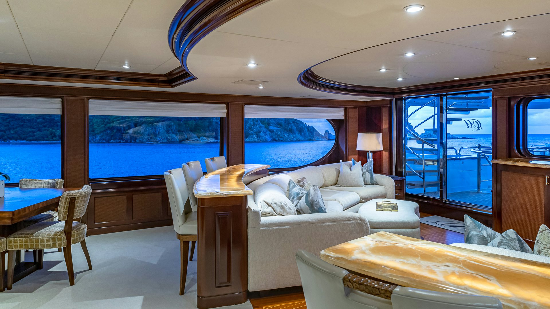 a room with a bed and a large window aboard MILESTONE Yacht for Charter