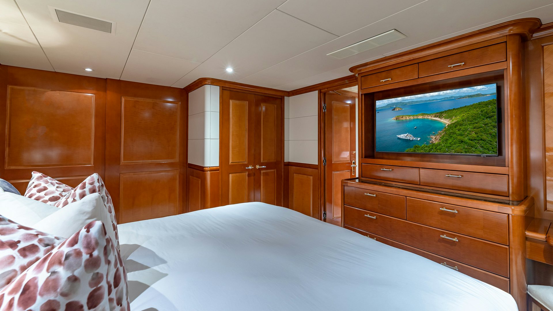 a bedroom with a tv and a bed aboard MILESTONE Yacht for Charter