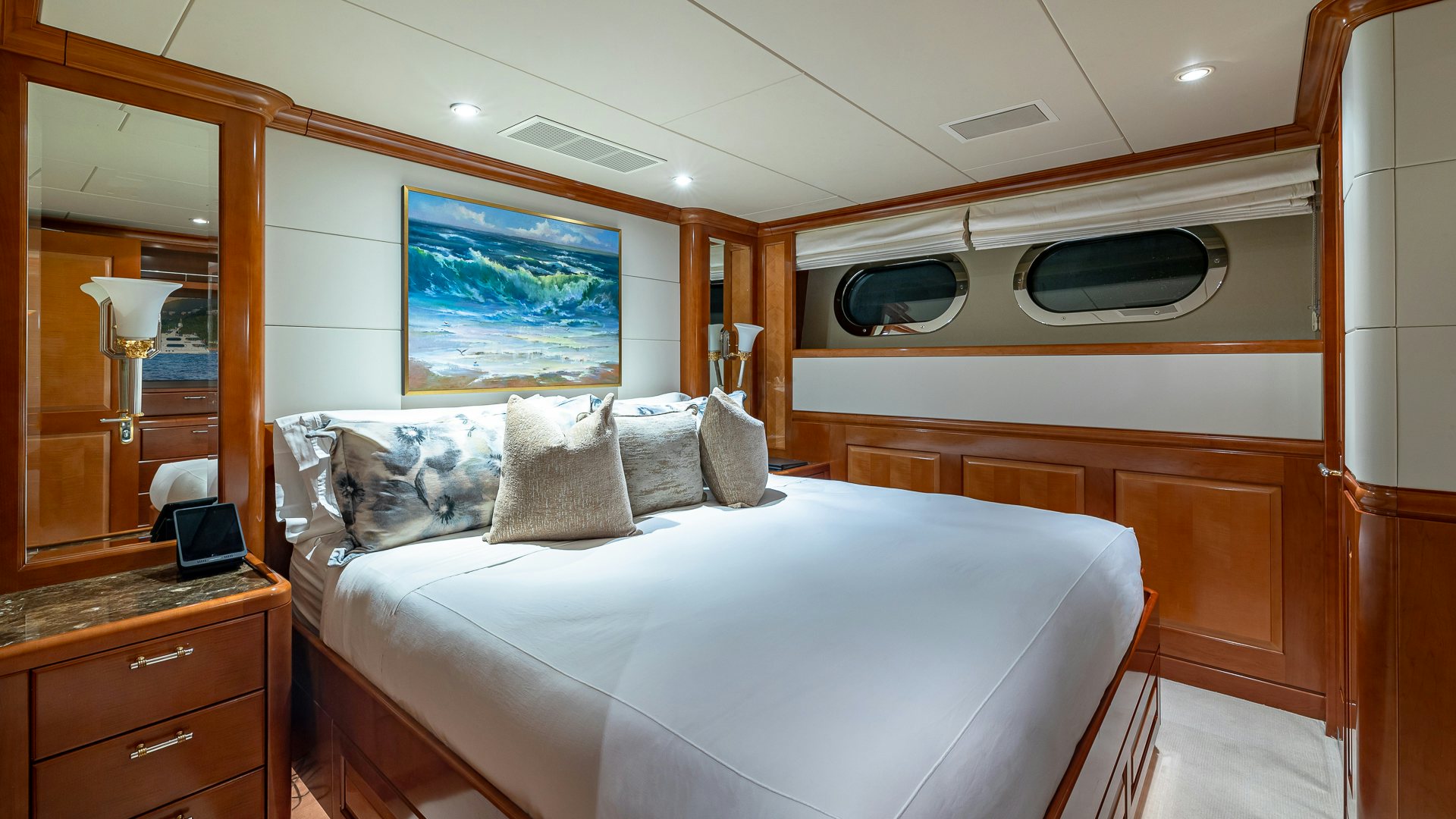 a bedroom with a bed and a desk aboard MILESTONE Yacht for Charter