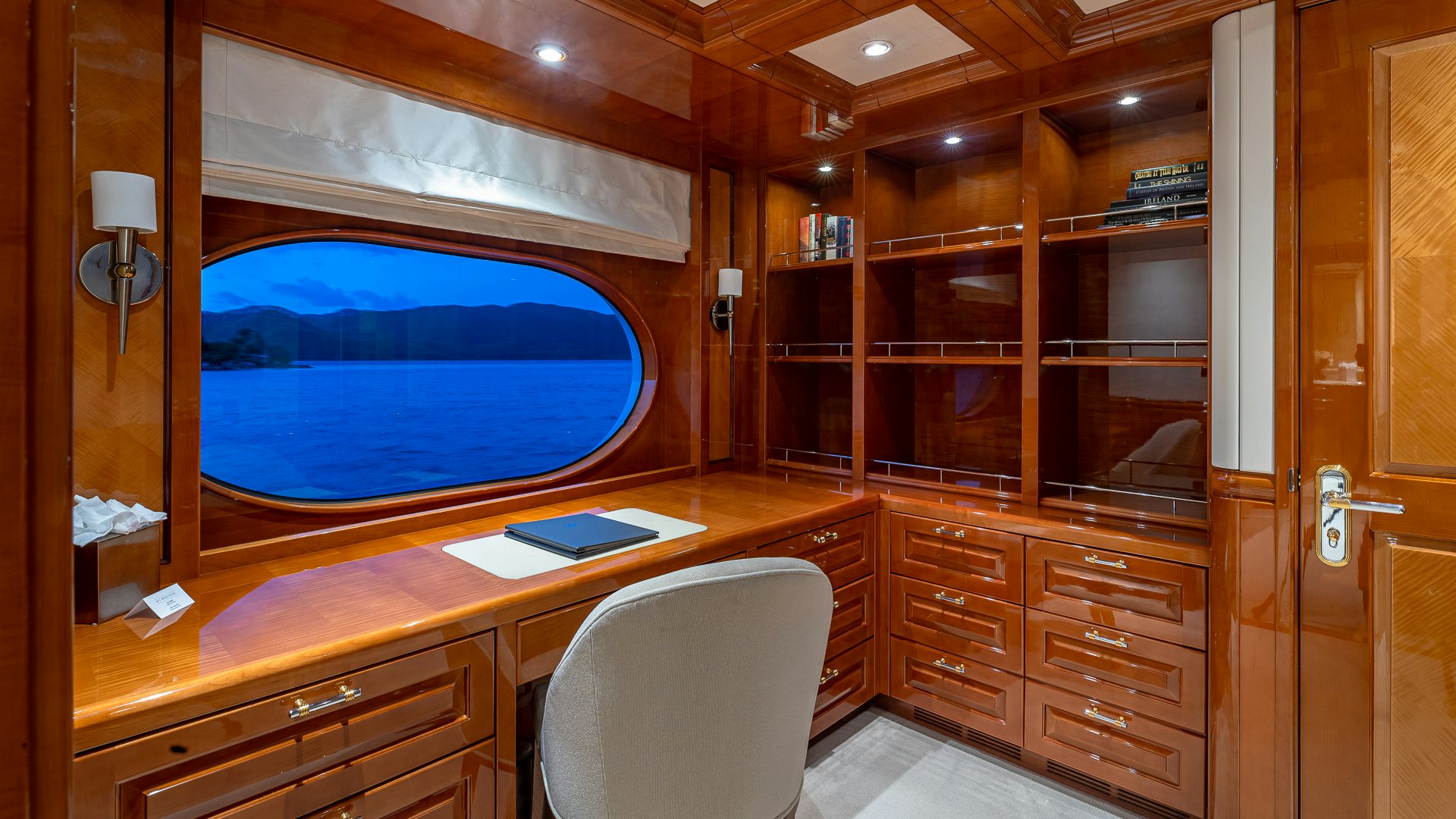a room with a desk and a chair aboard MILESTONE Yacht for Charter
