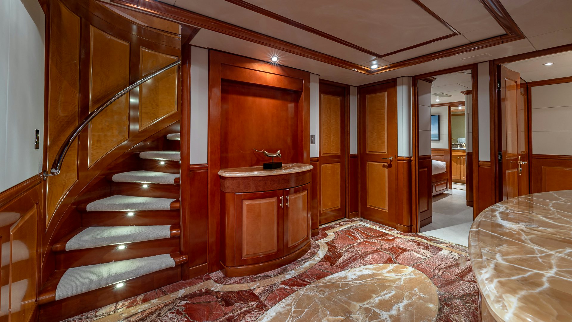 a large bathroom with a large wood door aboard MILESTONE Yacht for Charter