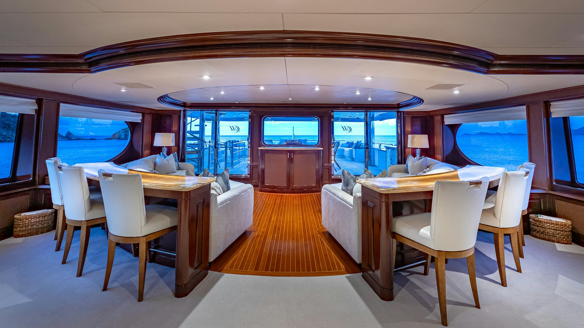 a room with tables and chairs aboard MILESTONE Yacht for Charter