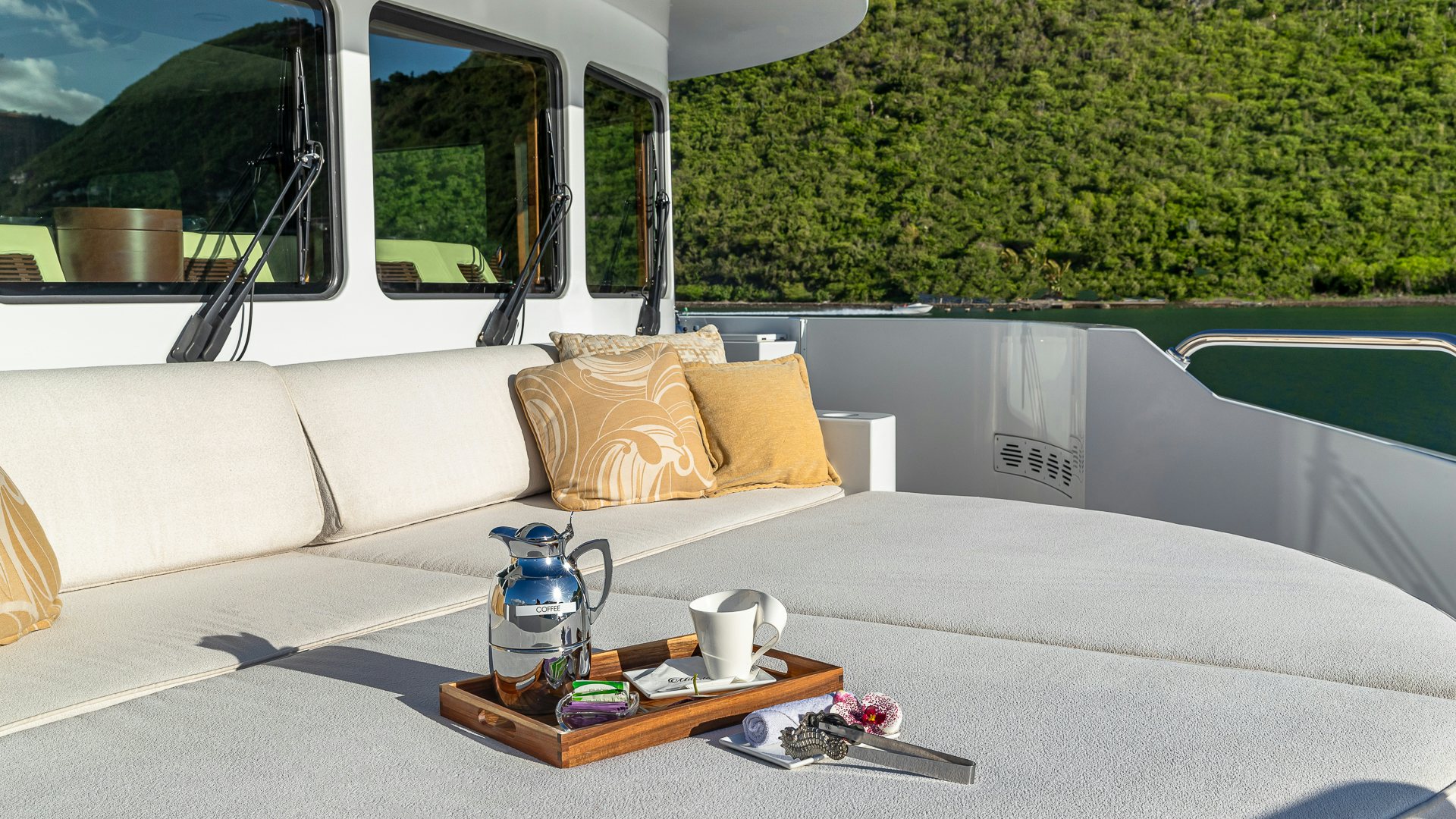 a white couch with a coffee table and a coffee table on a boat aboard MILESTONE Yacht for Charter