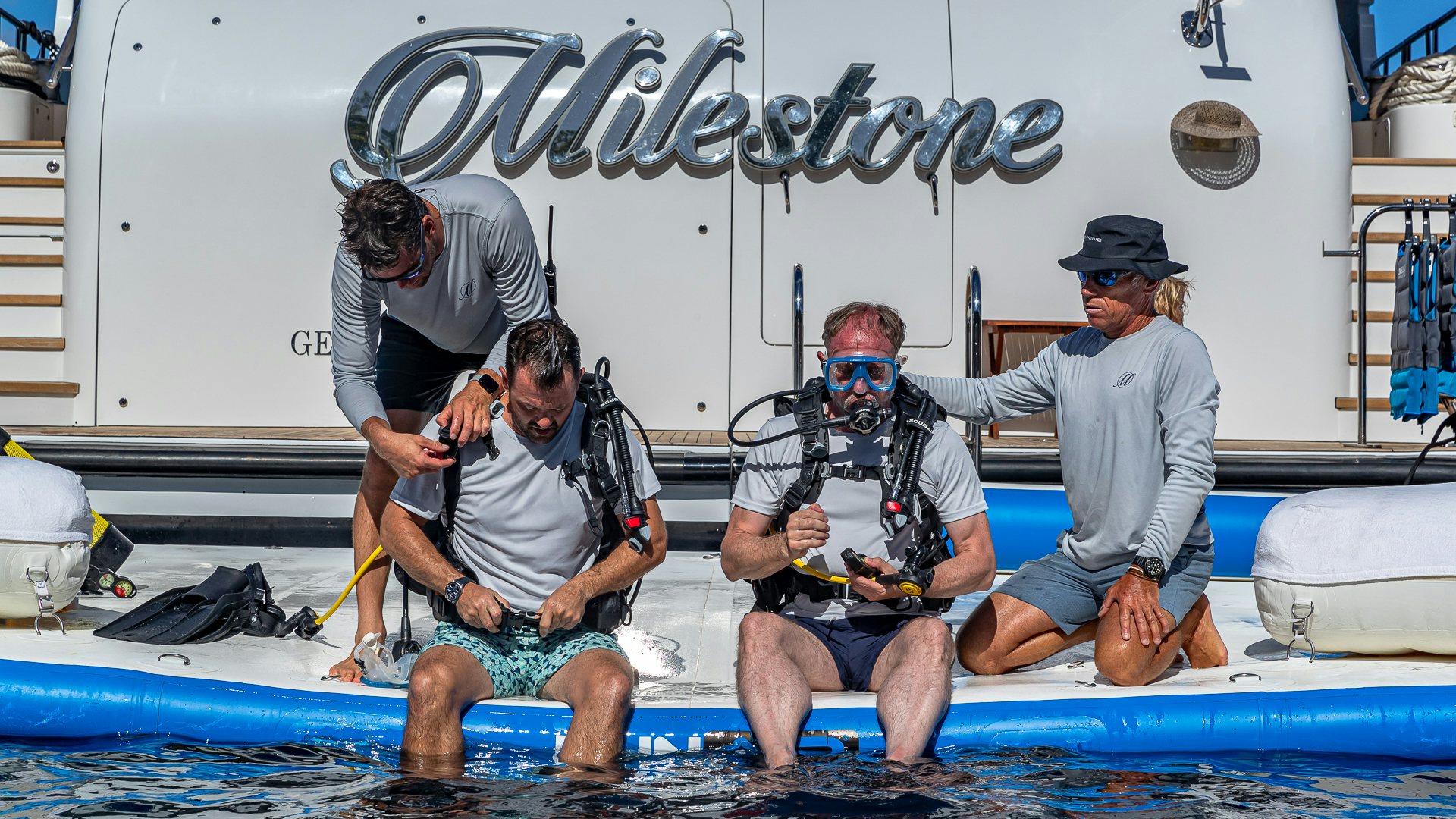 a group of people in scuba gear aboard MILESTONE Yacht for Charter