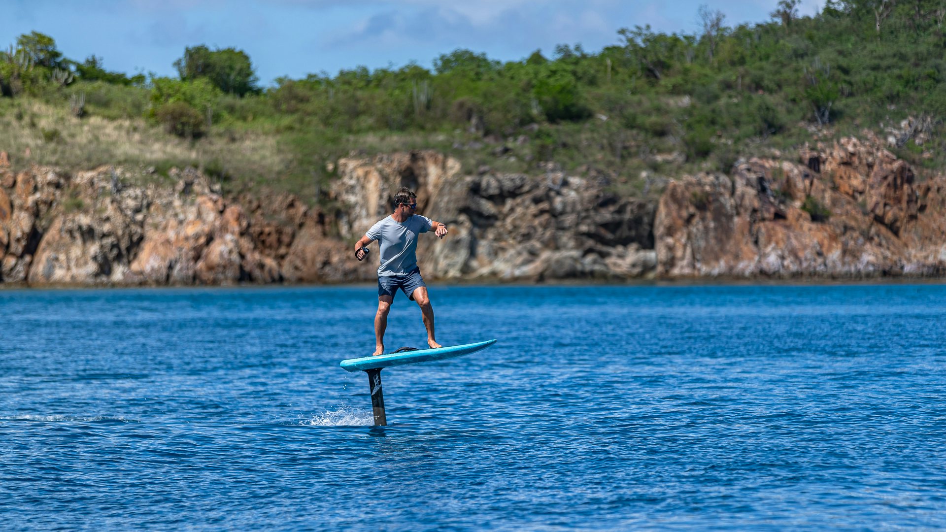 a man riding a surfboard aboard MILESTONE Yacht for Charter