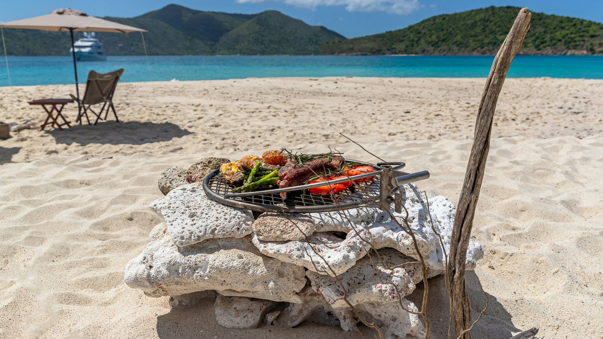 a picnic table on a beach aboard MILESTONE Yacht for Charter