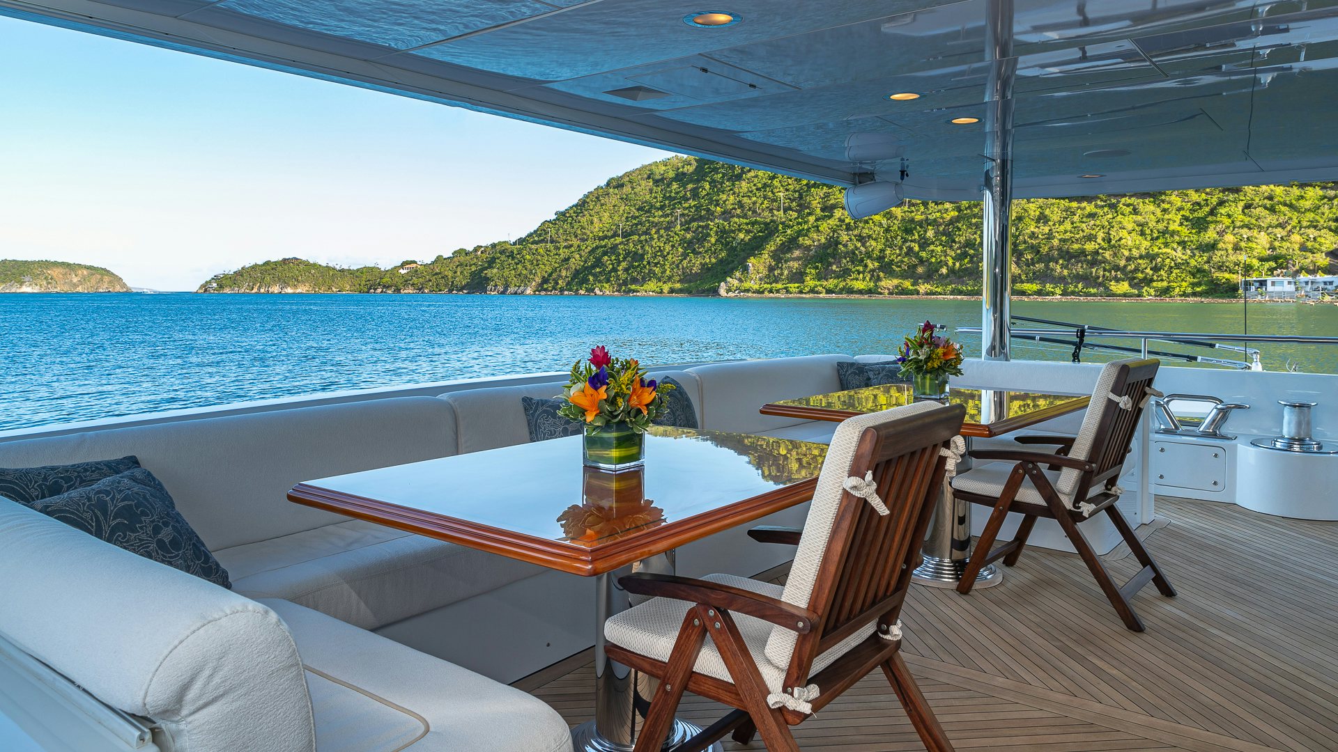 a table and chairs on a deck aboard MILESTONE Yacht for Charter