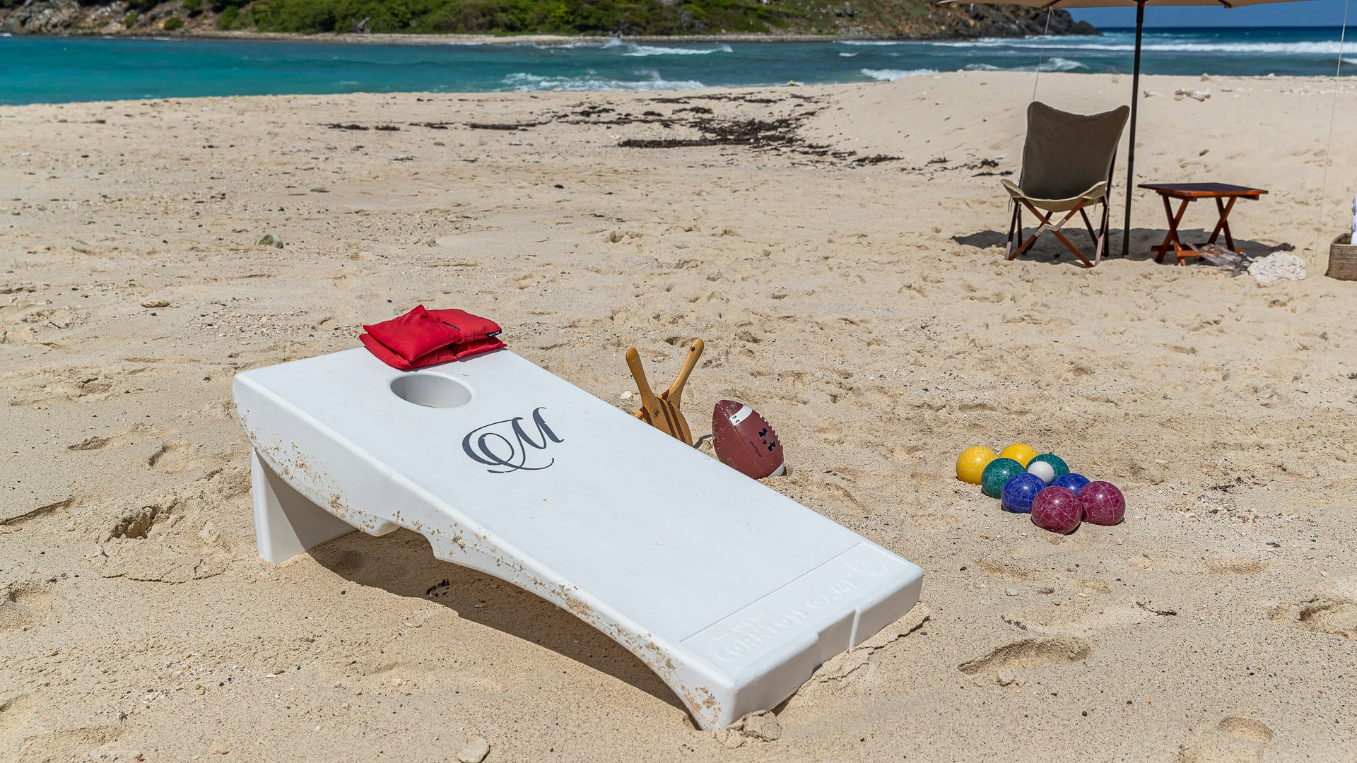 a surfboard and chair on a beach aboard MILESTONE Yacht for Charter