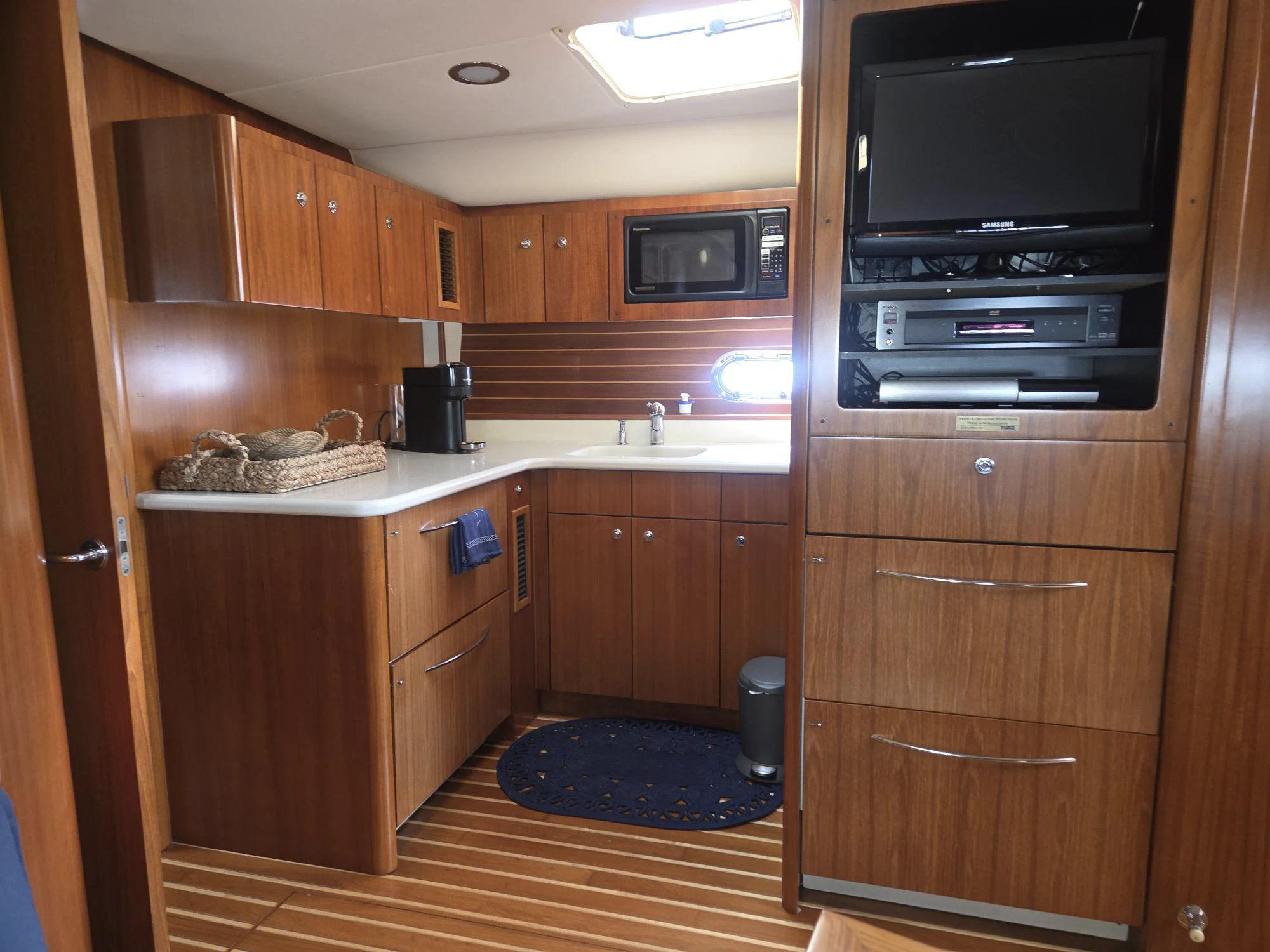 a kitchen with wooden cabinets aboard GOOD ENERGY TOO Yacht for Sale