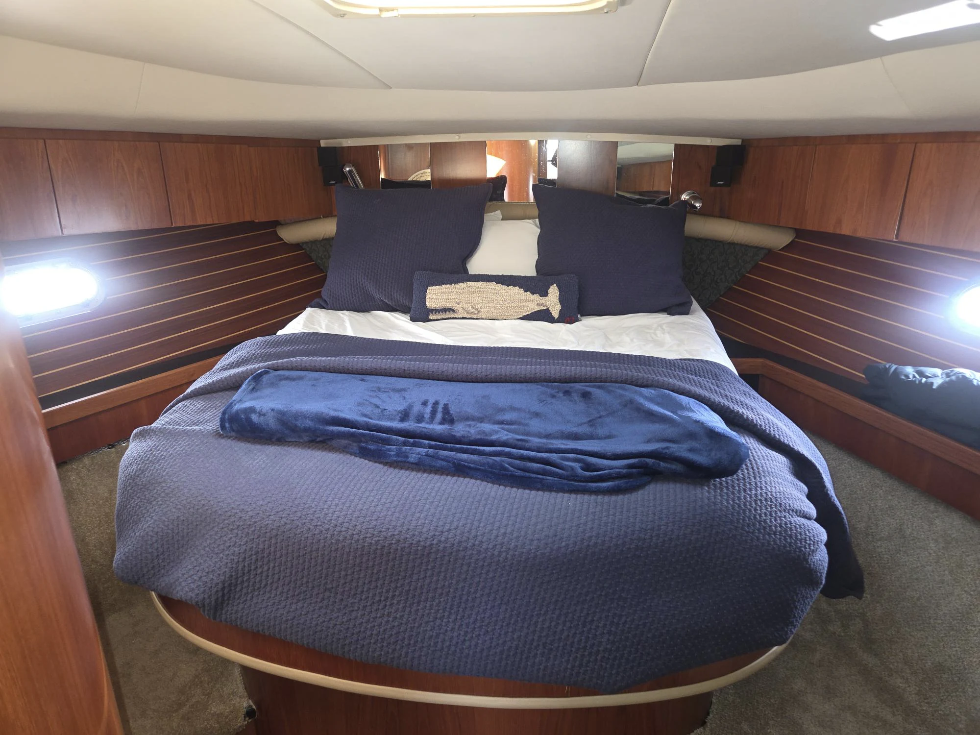 a bed with blue sheets aboard GOOD ENERGY TOO Yacht for Sale