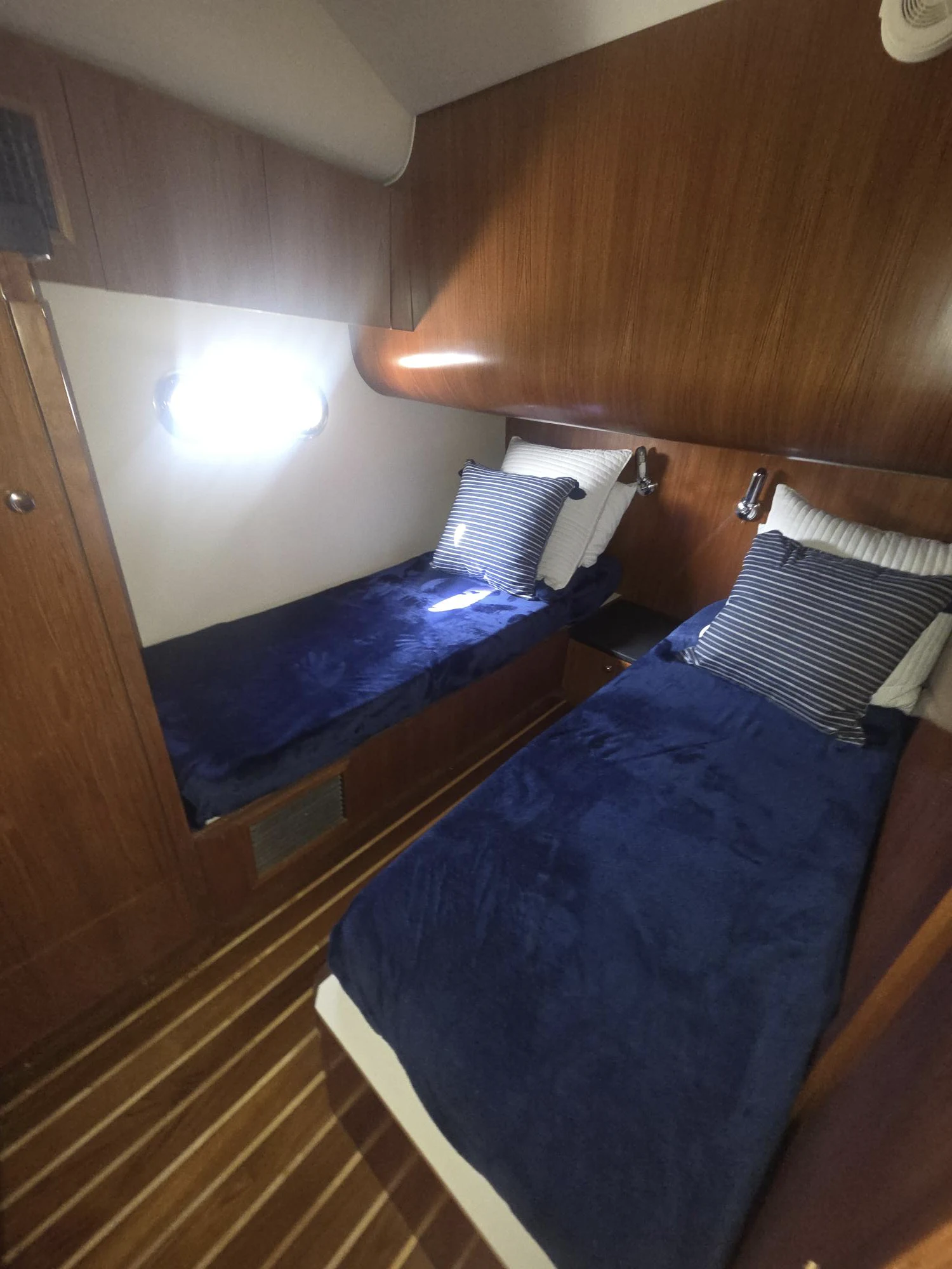a view of a room with a bed and a blue blanket aboard GOOD ENERGY TOO Yacht for Sale