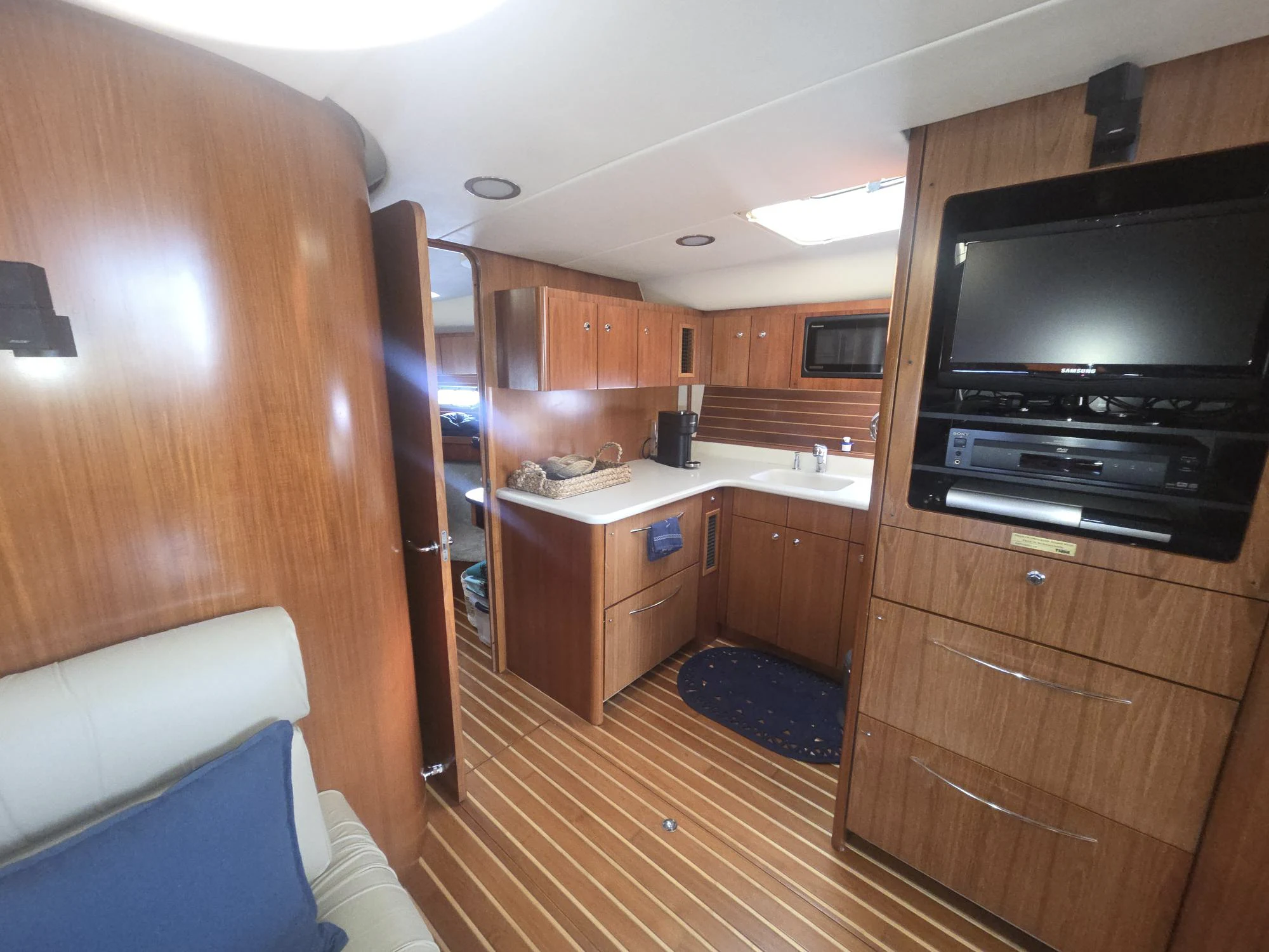 a kitchen with wooden cabinets aboard GOOD ENERGY TOO Yacht for Sale
