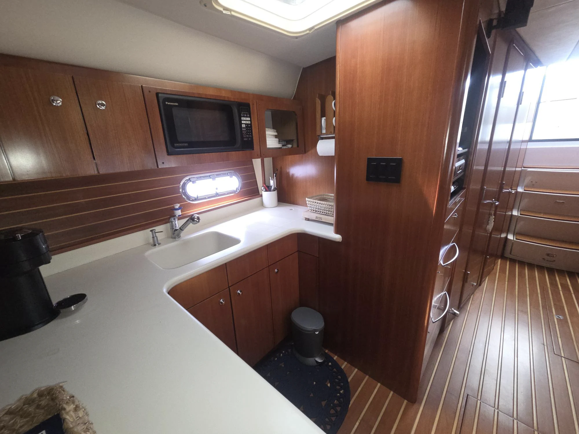 a bathroom with wooden cabinets aboard GOOD ENERGY TOO Yacht for Sale