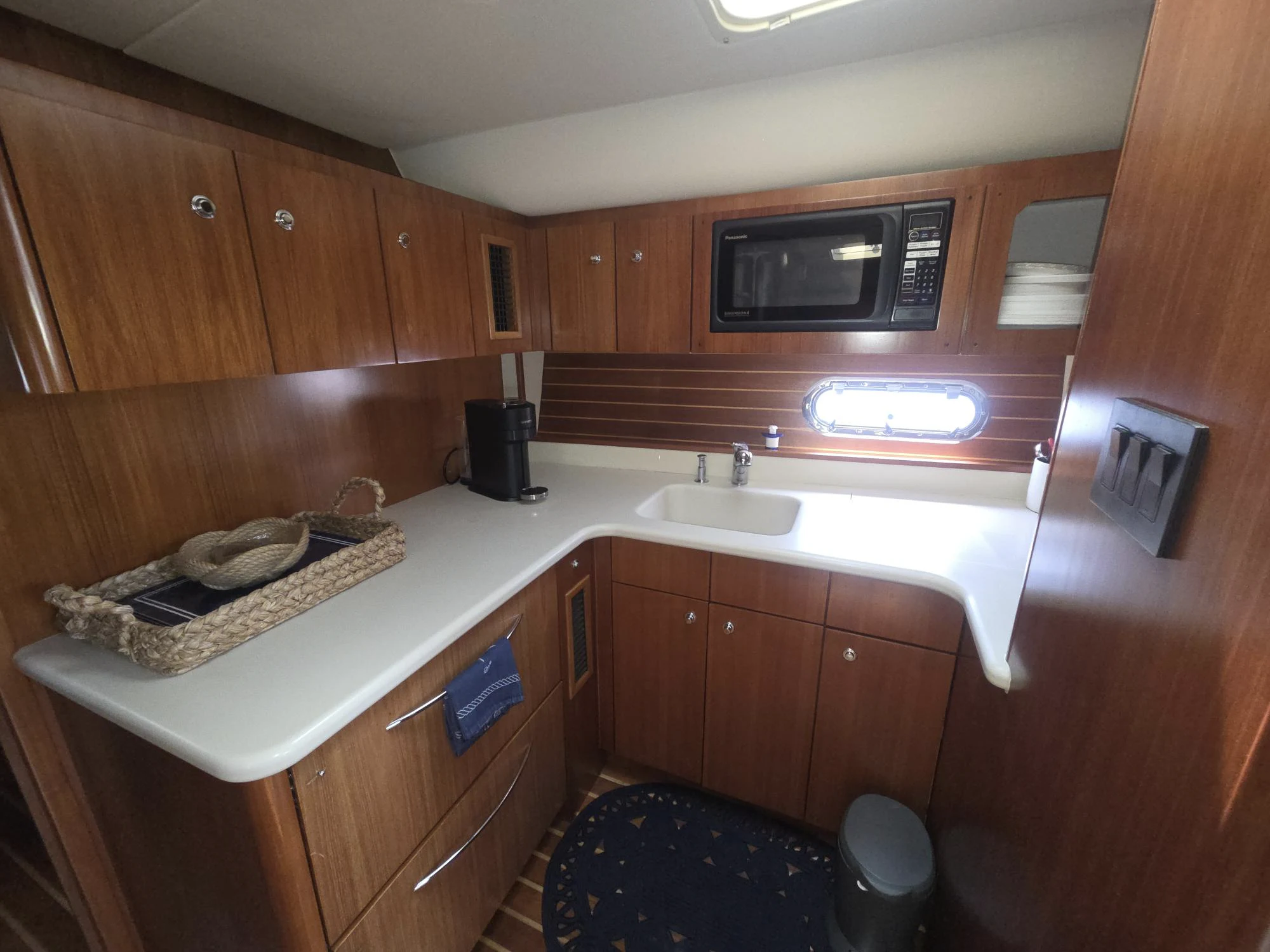 a kitchen with wooden cabinets aboard GOOD ENERGY TOO Yacht for Sale