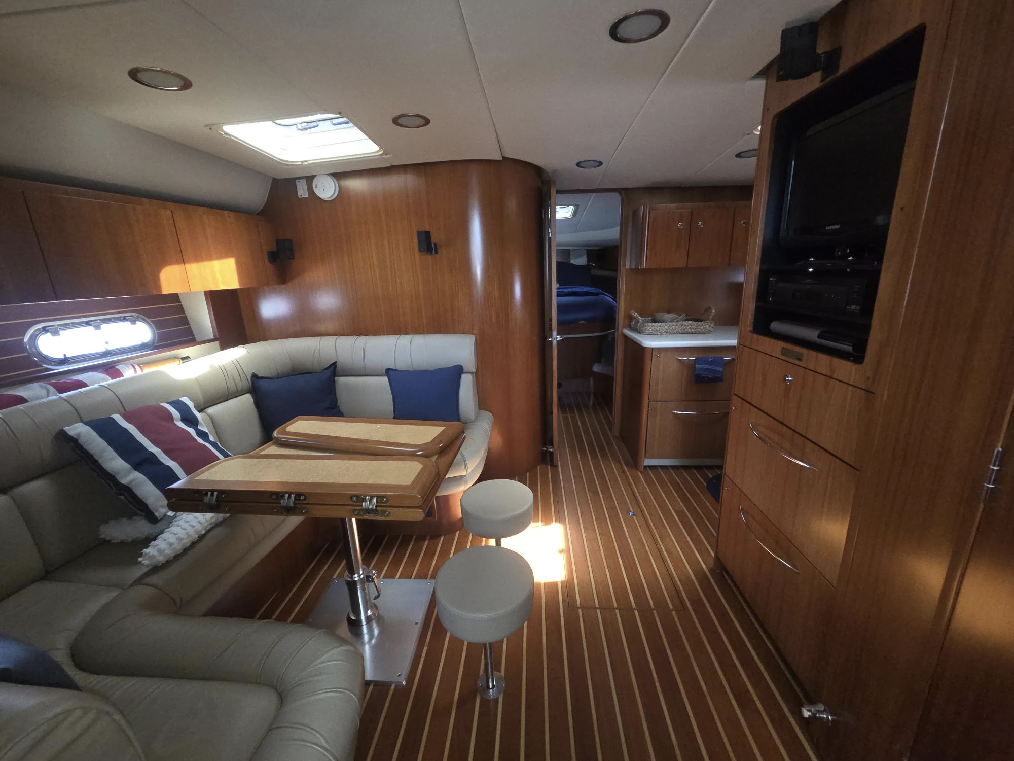 a living room with a couch and a television aboard GOOD ENERGY TOO Yacht for Sale