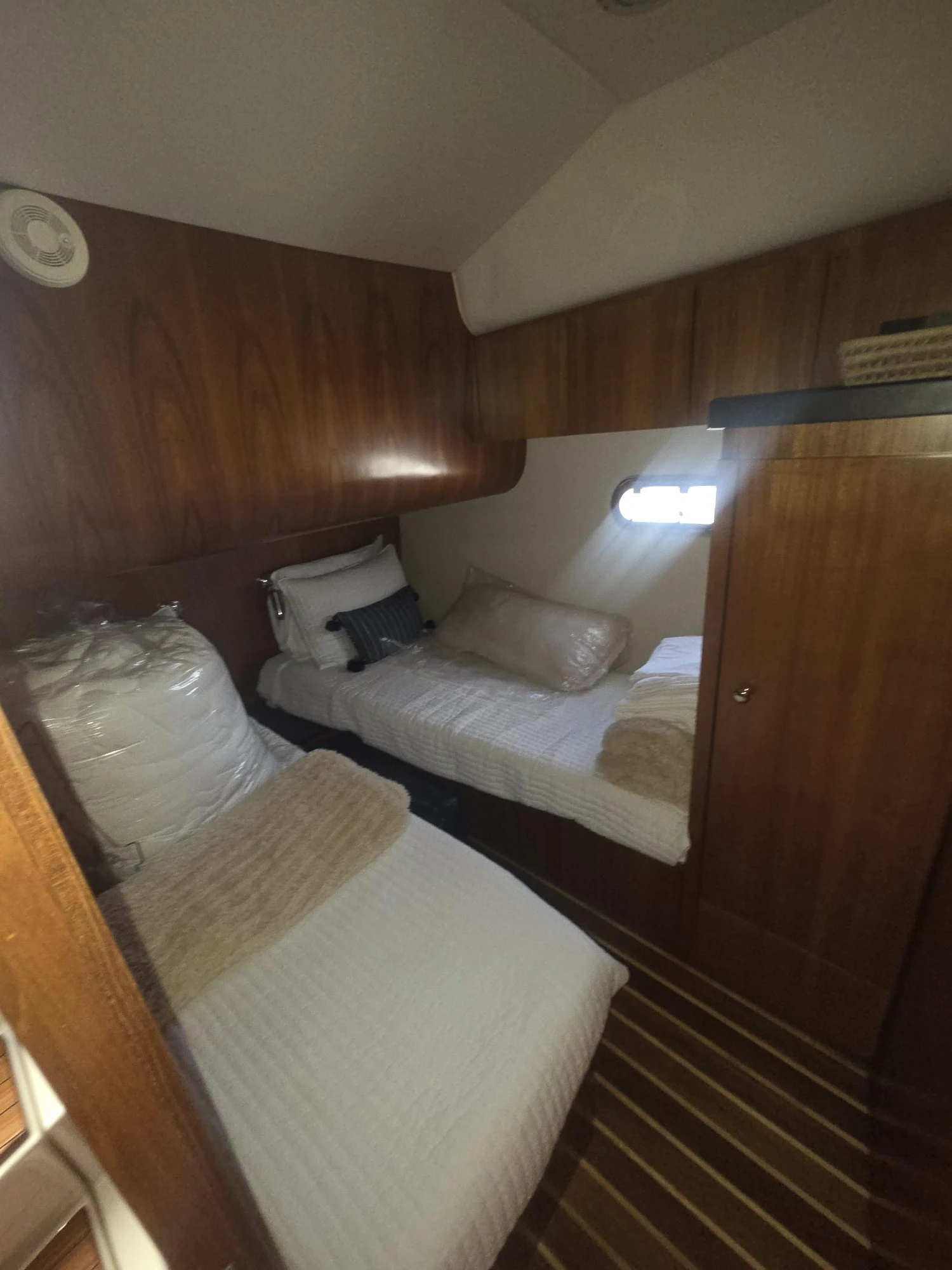a room with a bed and a chair aboard GOOD ENERGY TOO Yacht for Sale