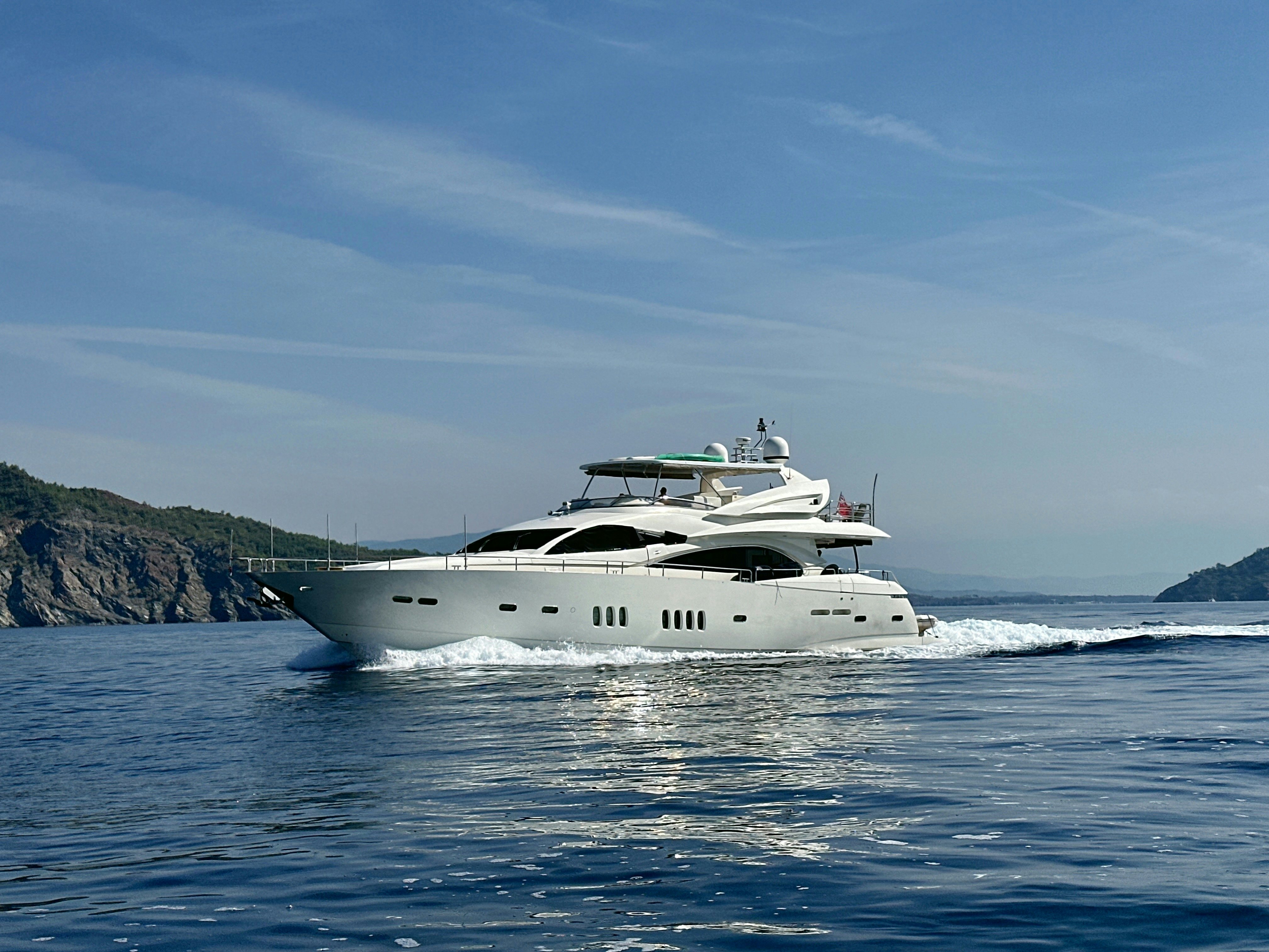 a white boat on the water aboard SWORDFISH 68 Yacht for Sale