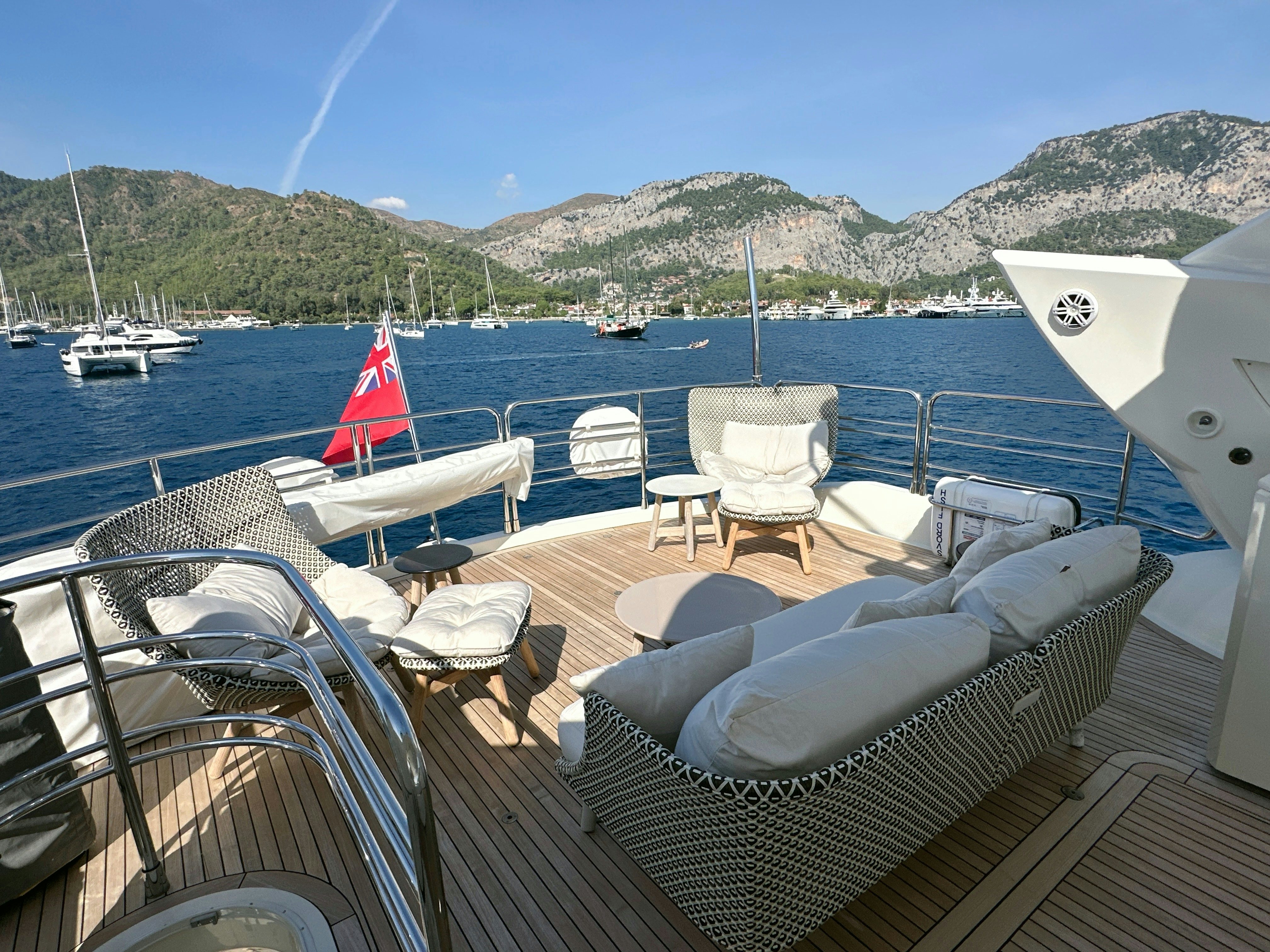 a deck with chairs and boats on it aboard SWORDFISH 68 Yacht for Sale