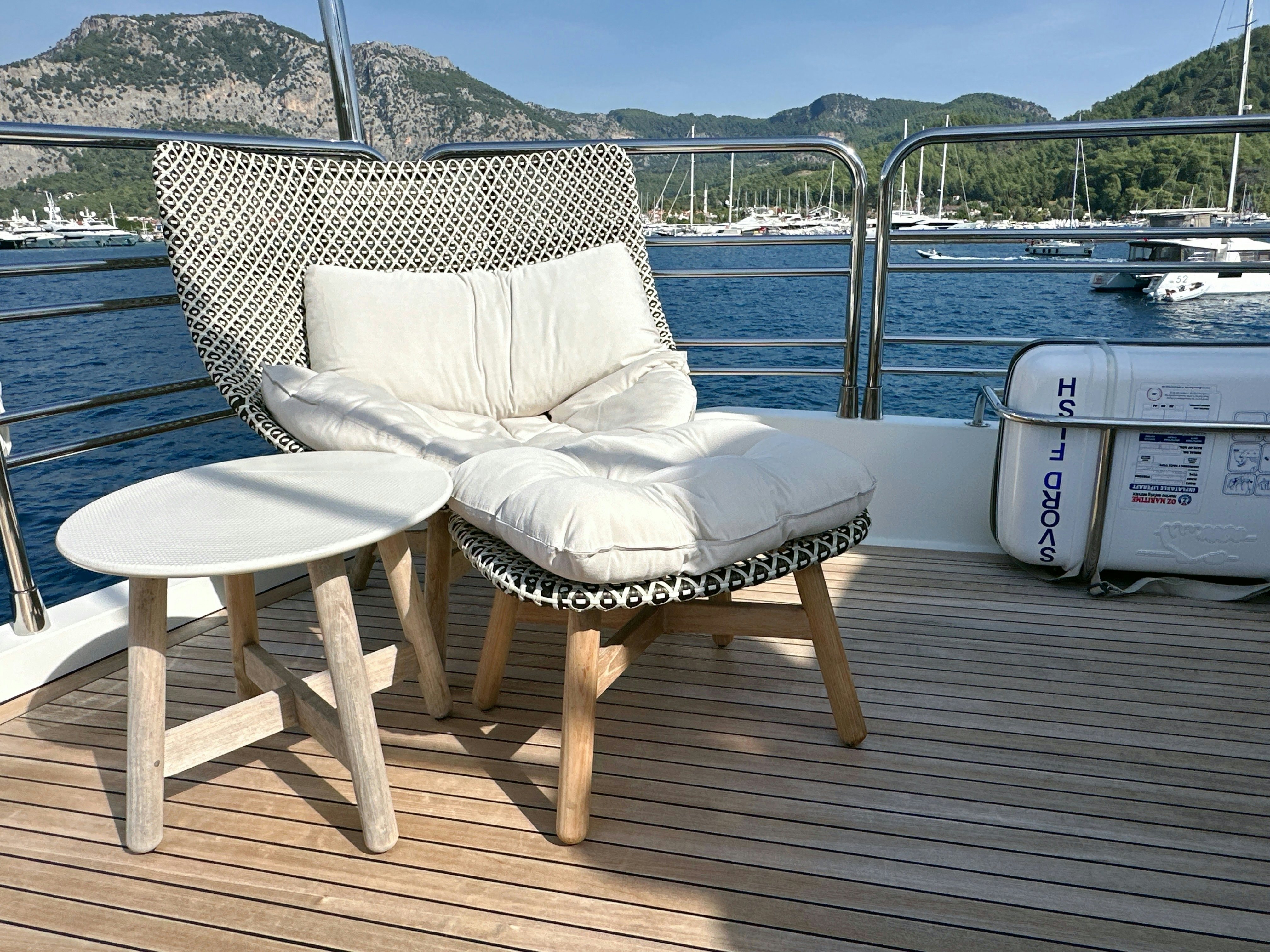 a bench on a deck overlooking a body of water aboard SWORDFISH 68 Yacht for Sale