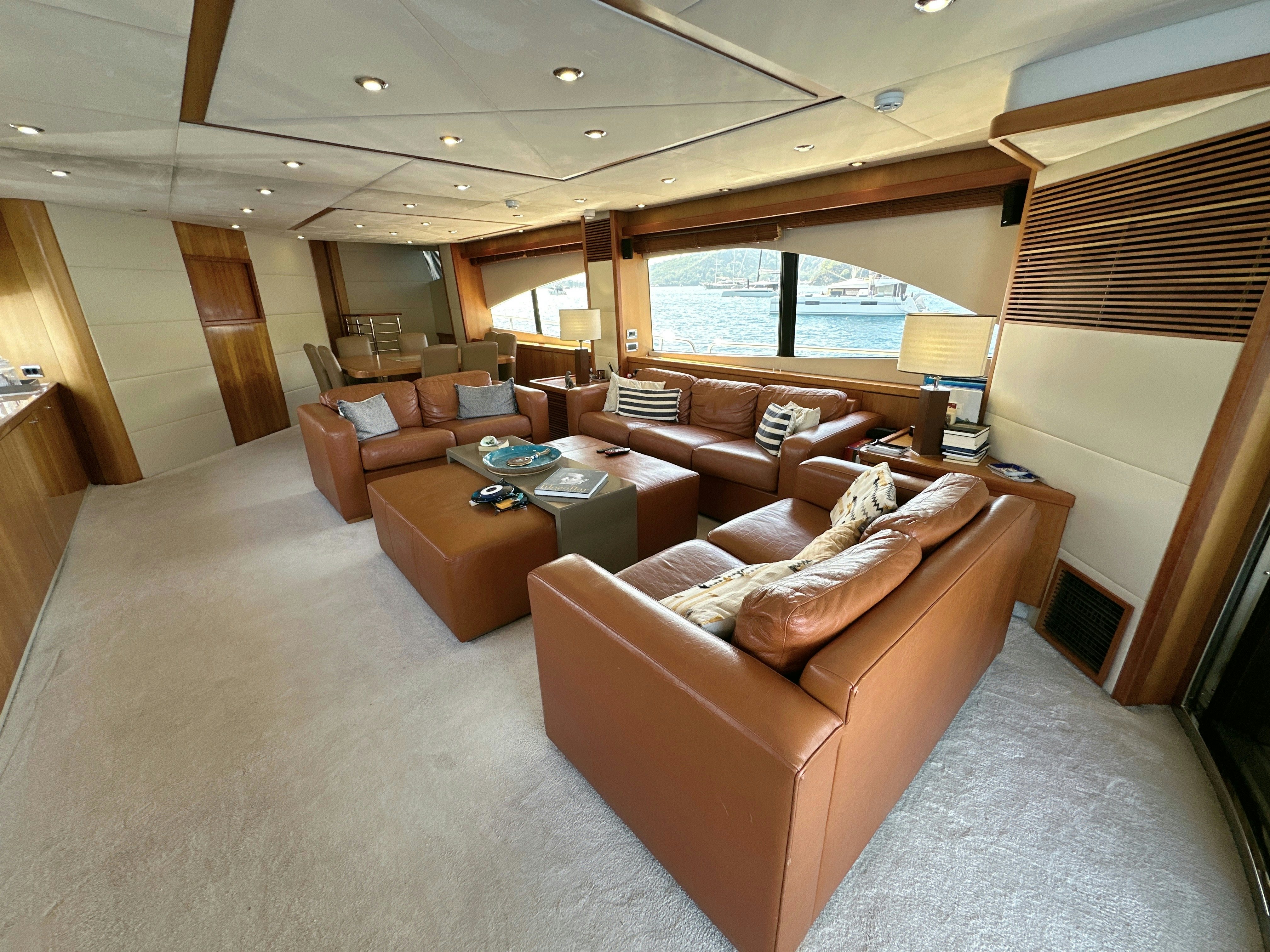 a living room with a couch and a table aboard SWORDFISH 68 Yacht for Sale