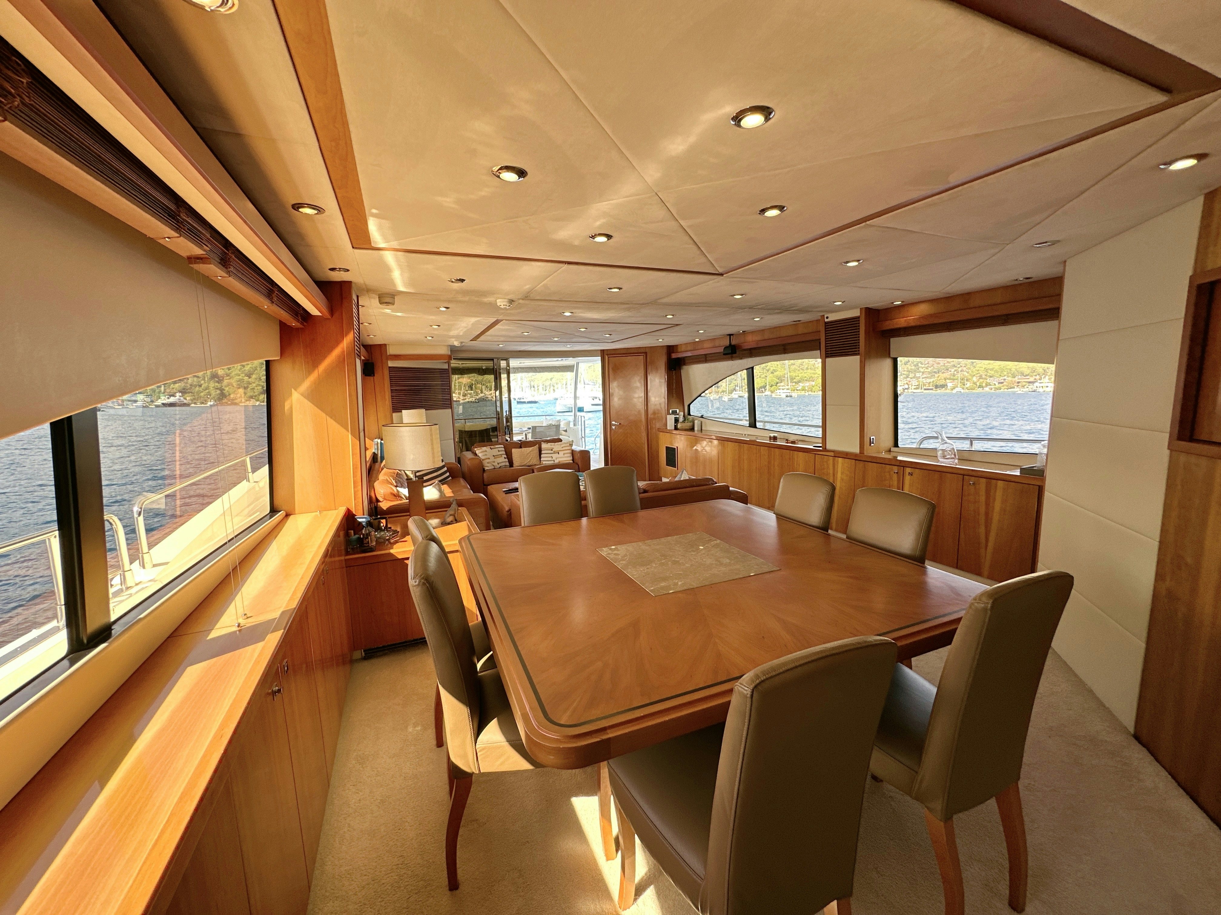 a room with a table and chairs aboard SWORDFISH 68 Yacht for Sale