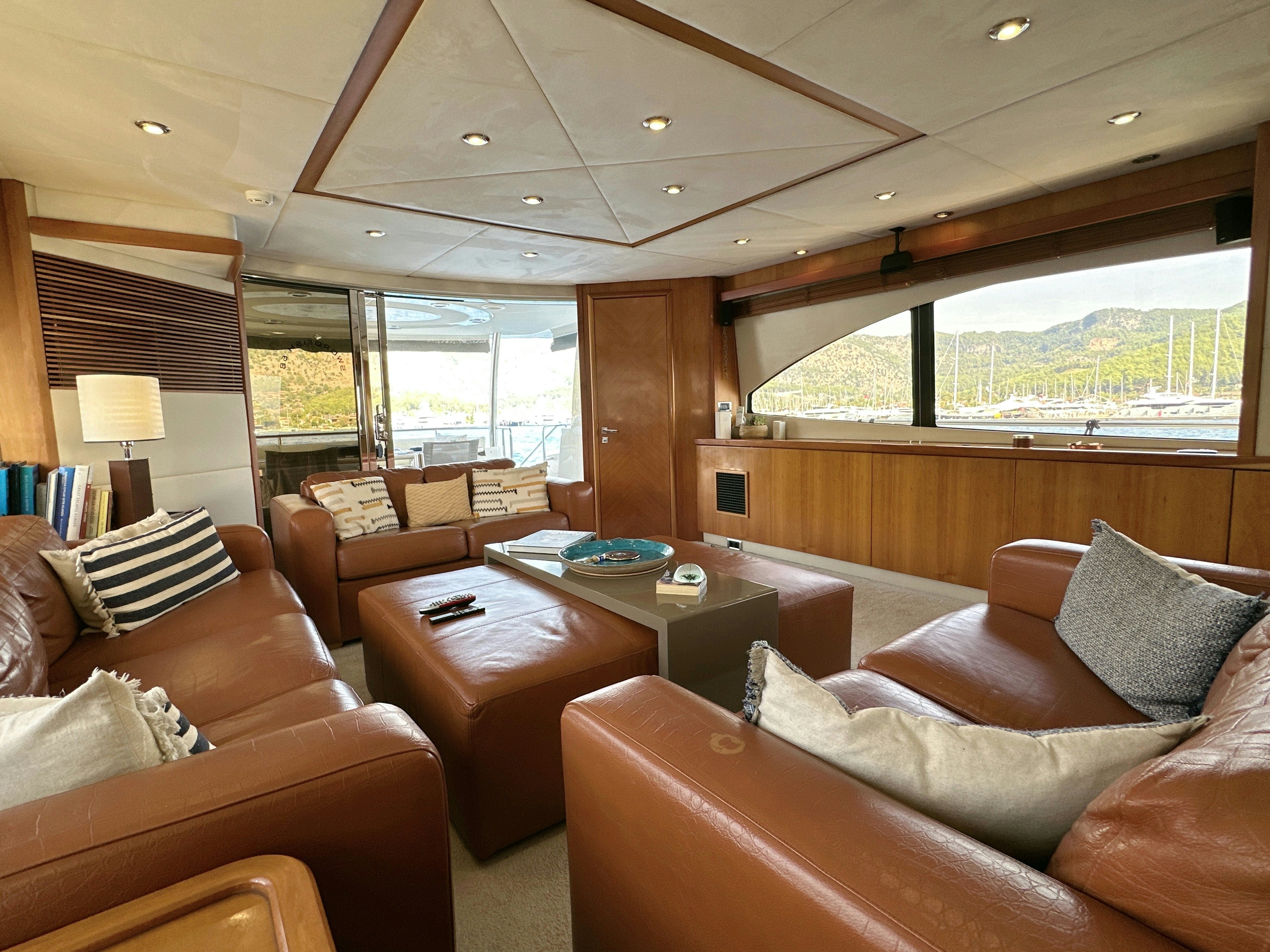 a living room with a large window aboard SWORDFISH 68 Yacht for Sale