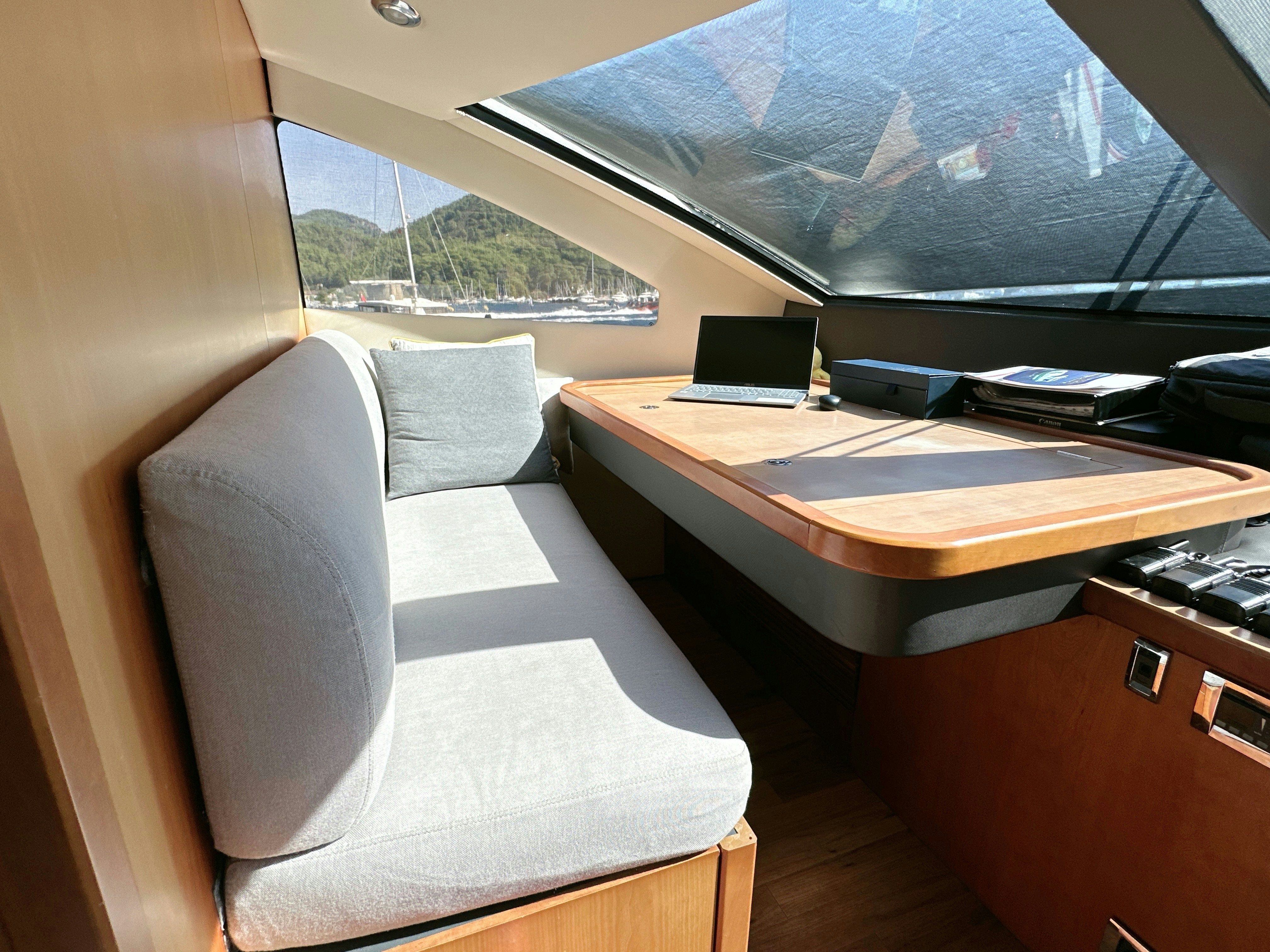 a room with a desk and a window aboard SWORDFISH 68 Yacht for Sale