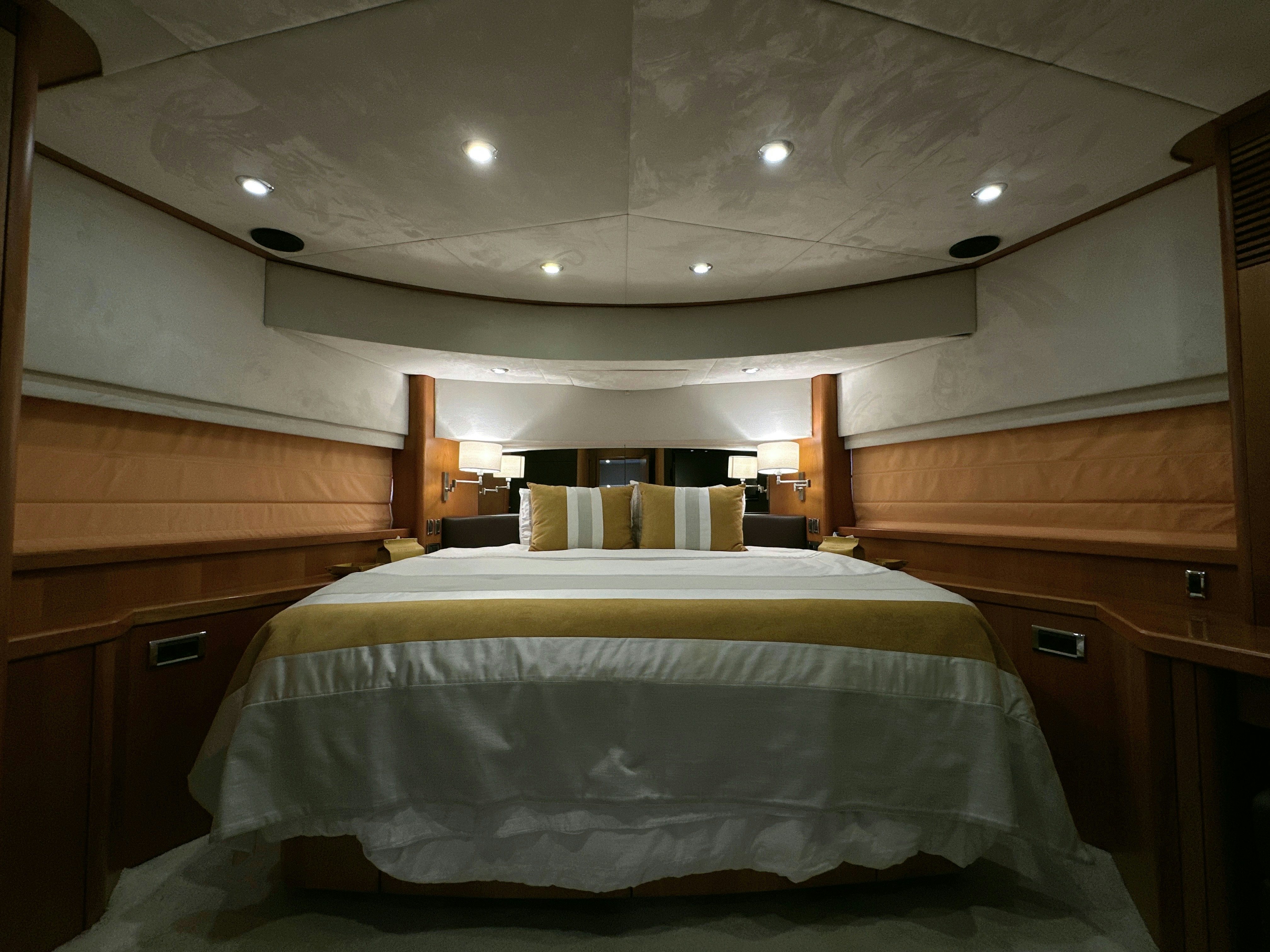 a room with a bed and a desk aboard SWORDFISH 68 Yacht for Sale