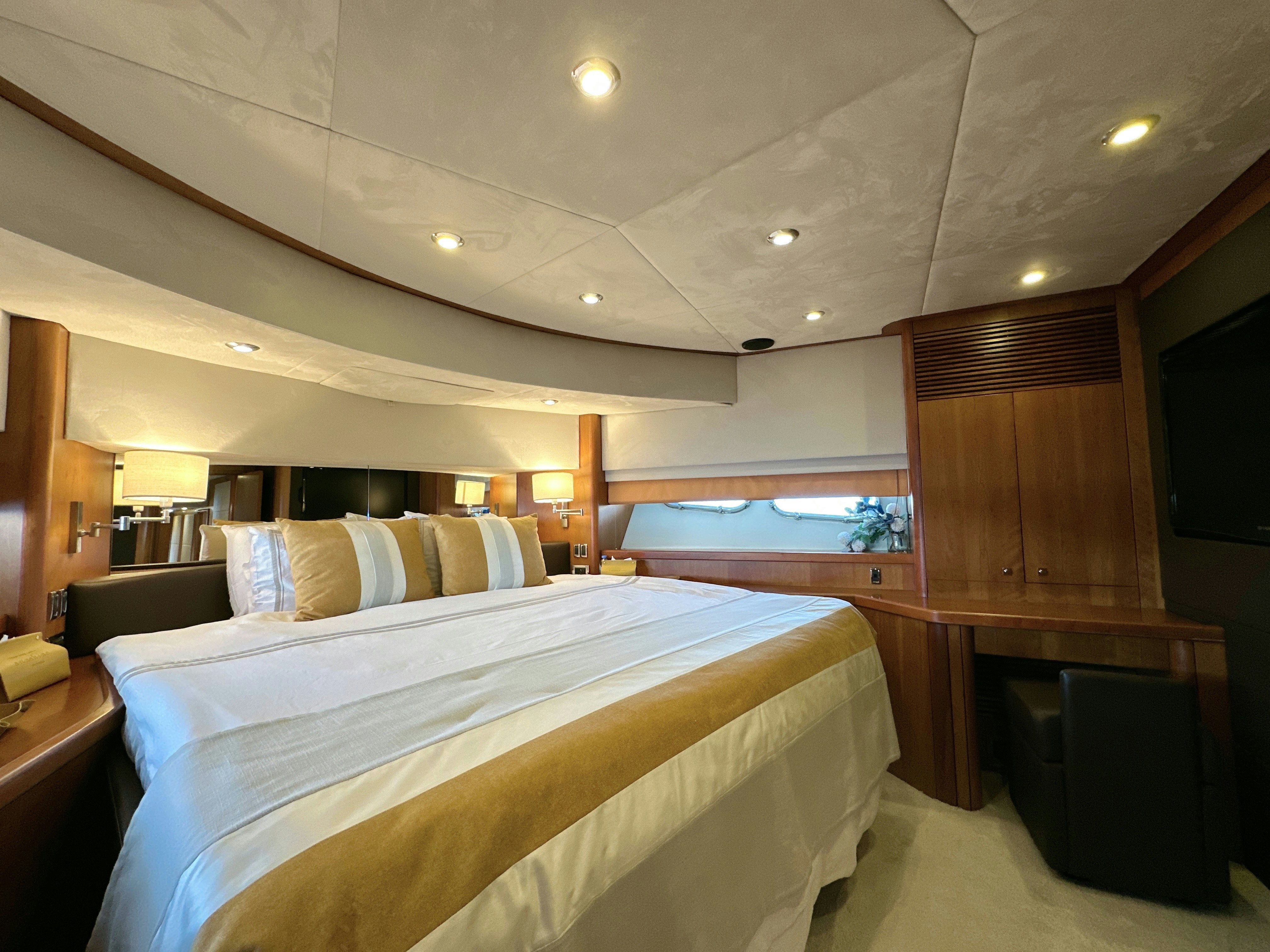 a room with a bed and a window aboard SWORDFISH 68 Yacht for Sale