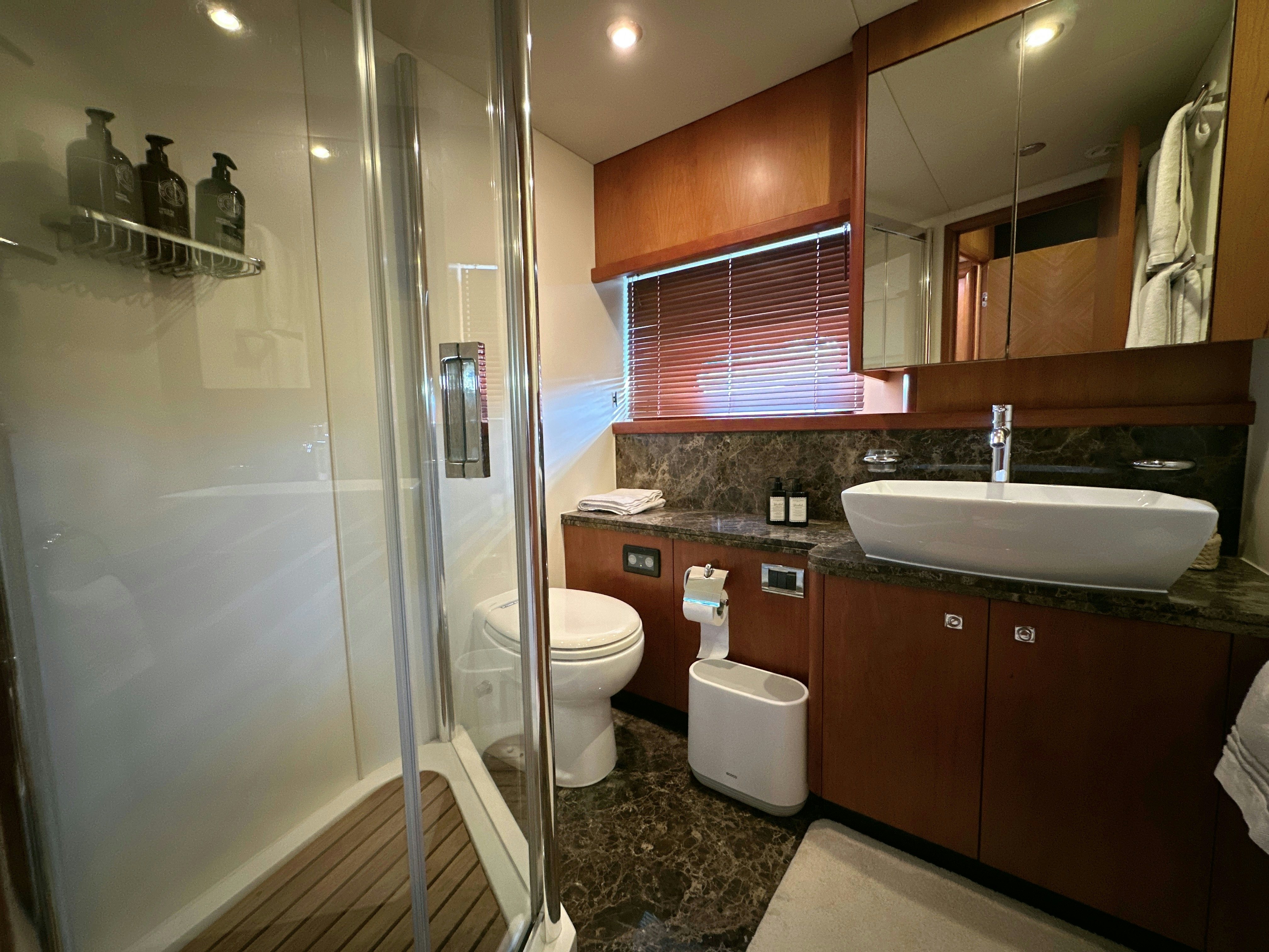 a bathroom with a glass shower aboard SWORDFISH 68 Yacht for Sale