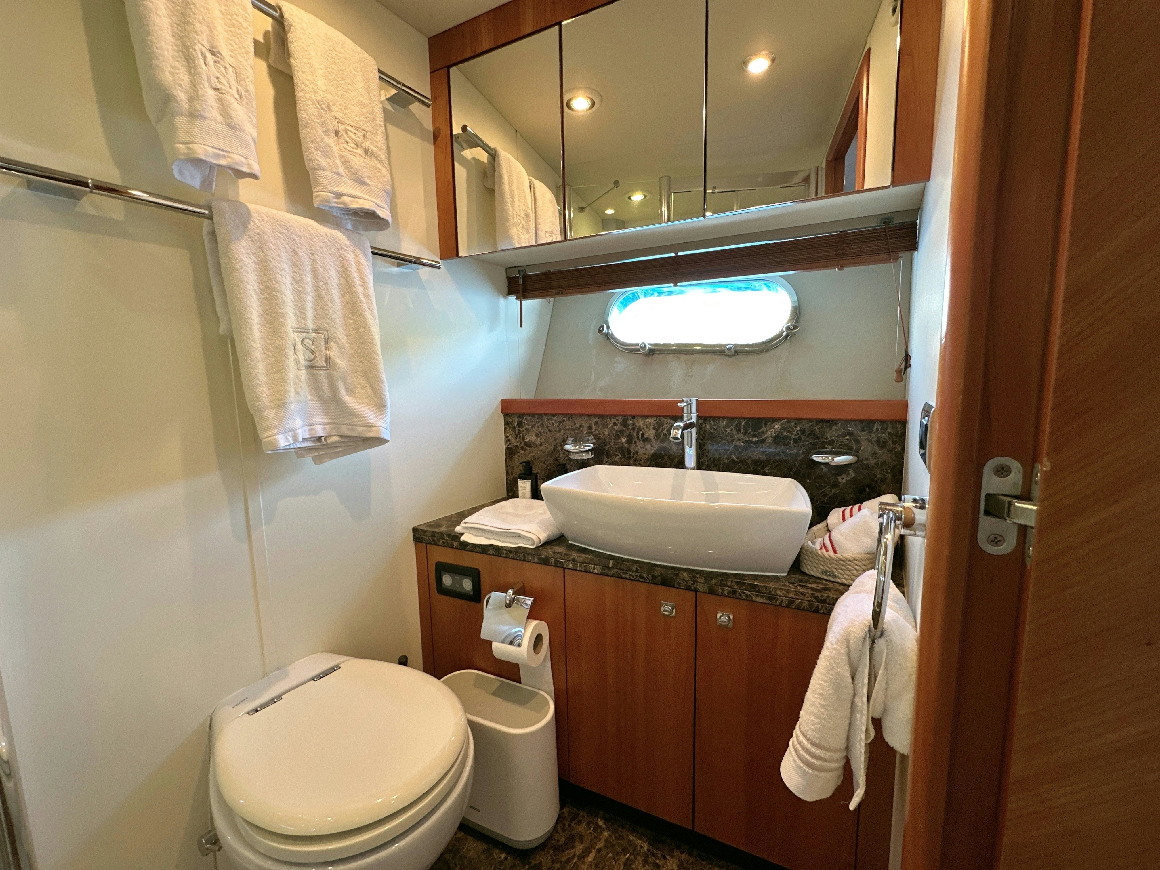 a bathroom with a sink and toilet aboard SWORDFISH 68 Yacht for Sale