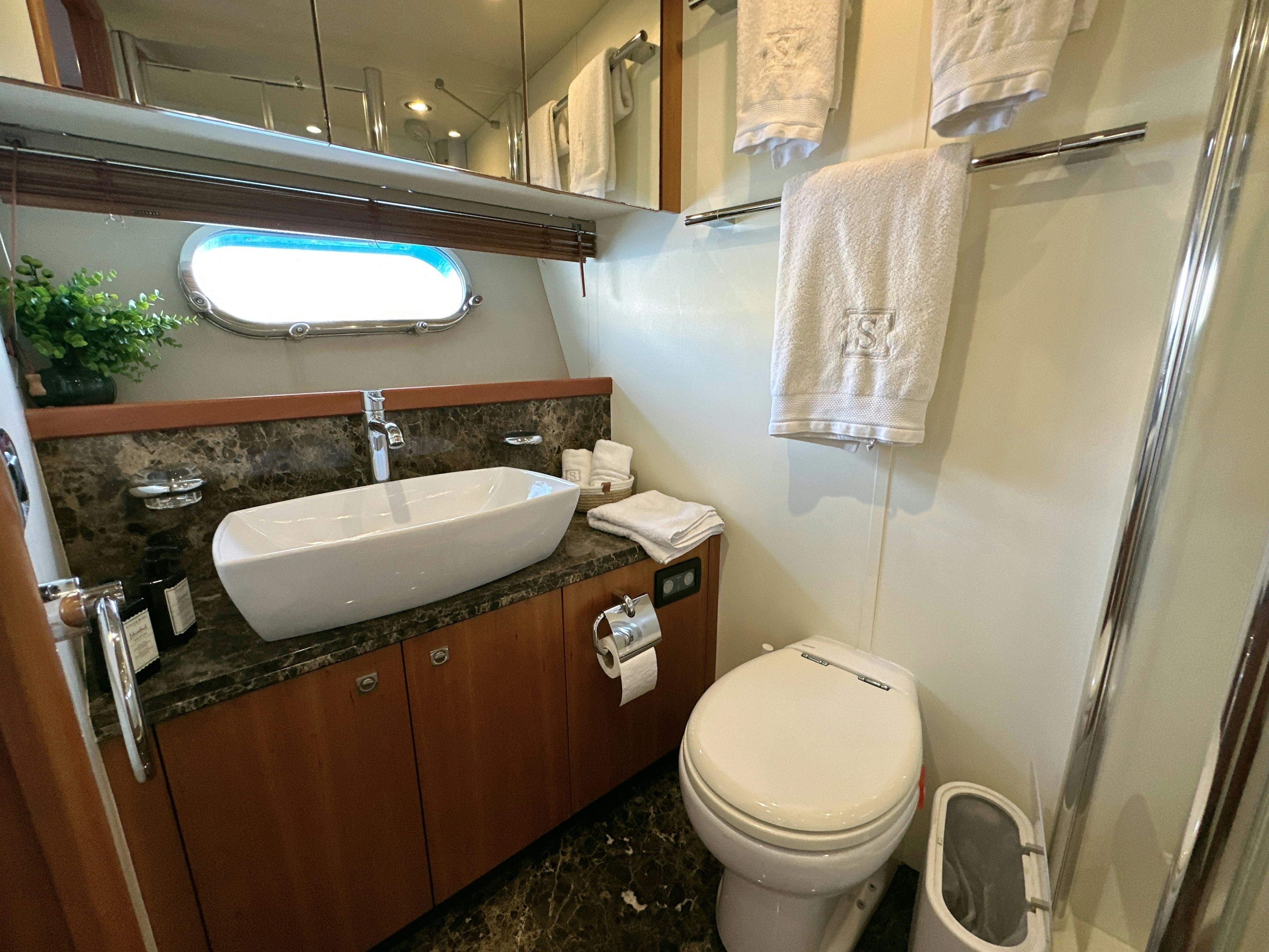 a bathroom with a sink and toilet aboard SWORDFISH 68 Yacht for Sale