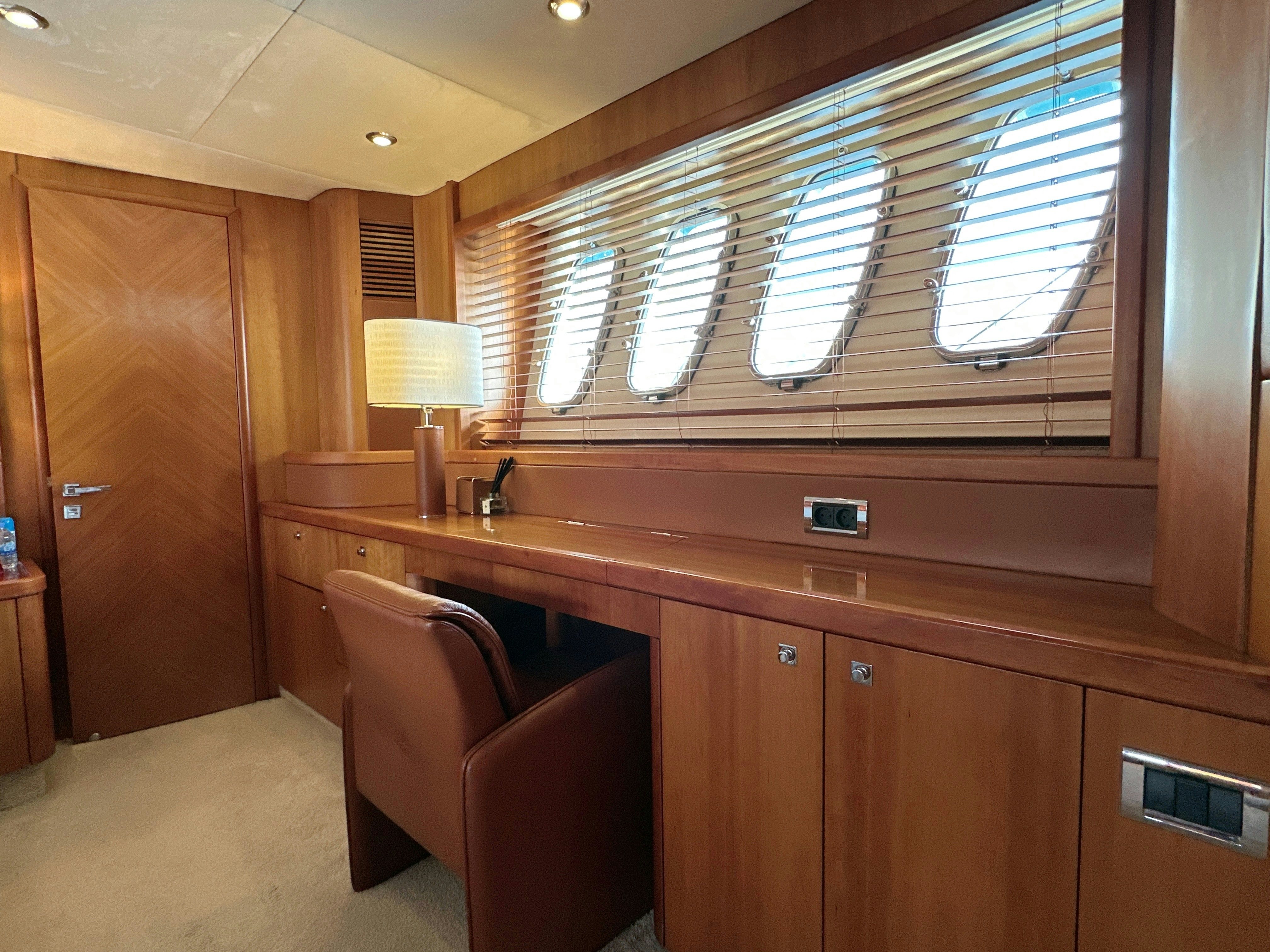 a room with a desk and a chair aboard SWORDFISH 68 Yacht for Sale