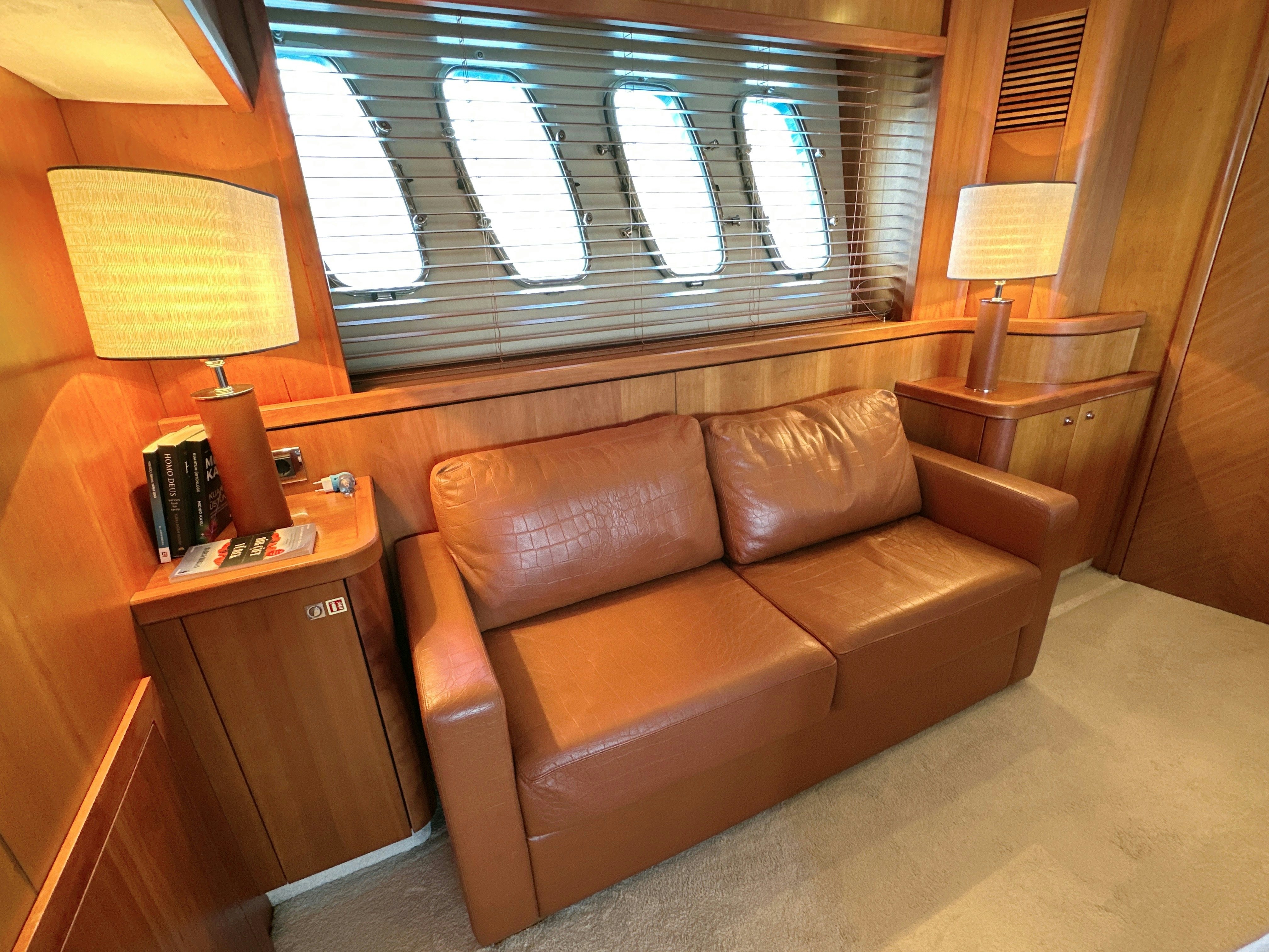 a brown leather couch in a living room aboard SWORDFISH 68 Yacht for Sale