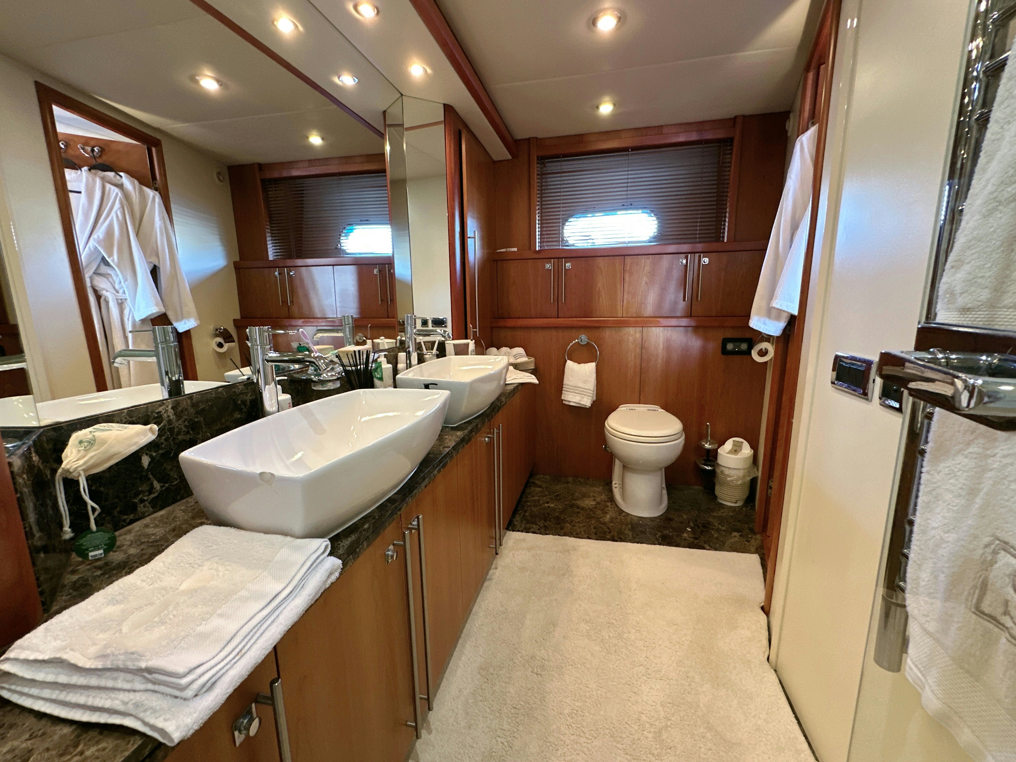 a bathroom with a sink and toilet aboard SWORDFISH 68 Yacht for Sale