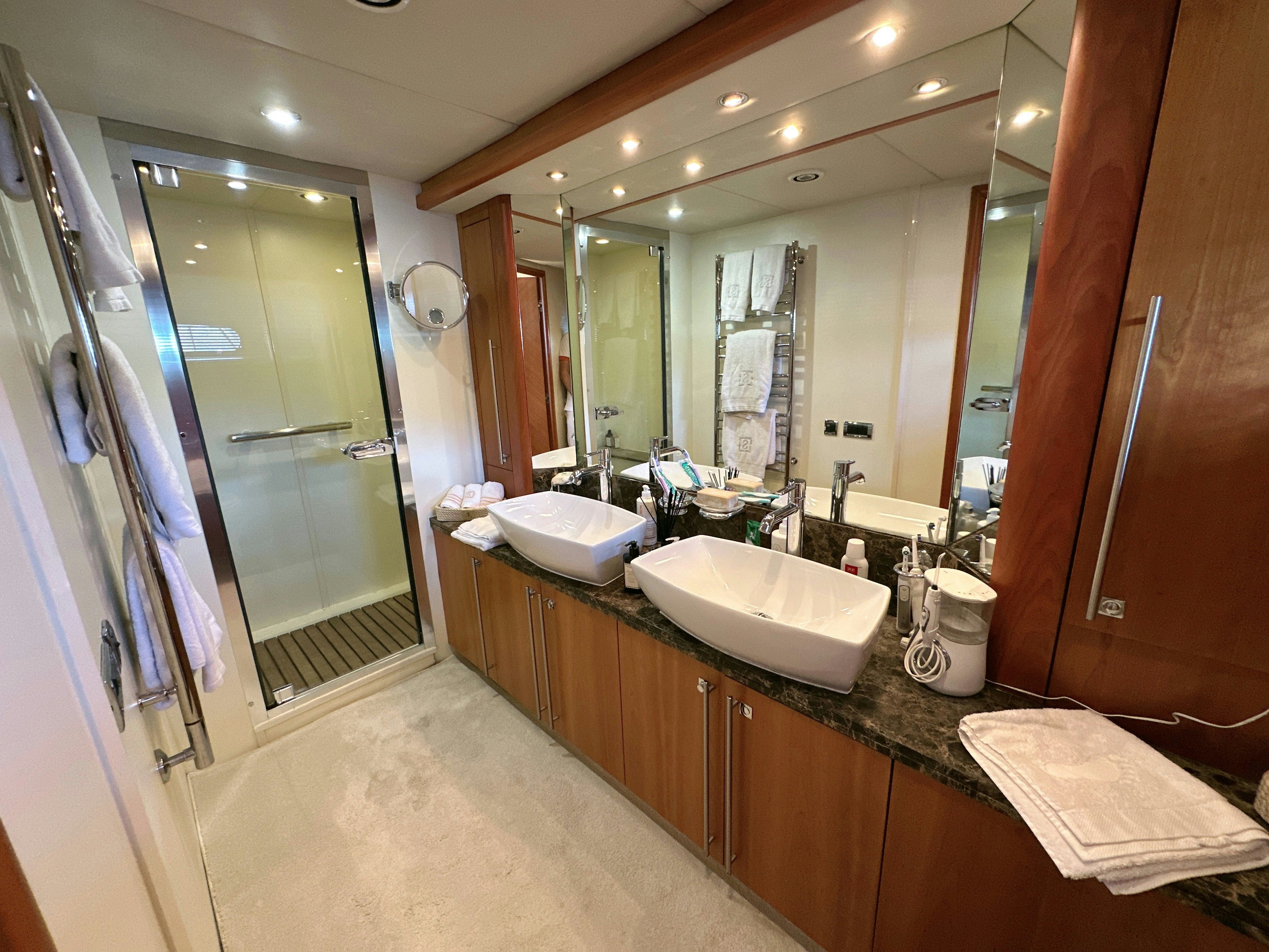 a bathroom with a large mirror aboard SWORDFISH 68 Yacht for Sale
