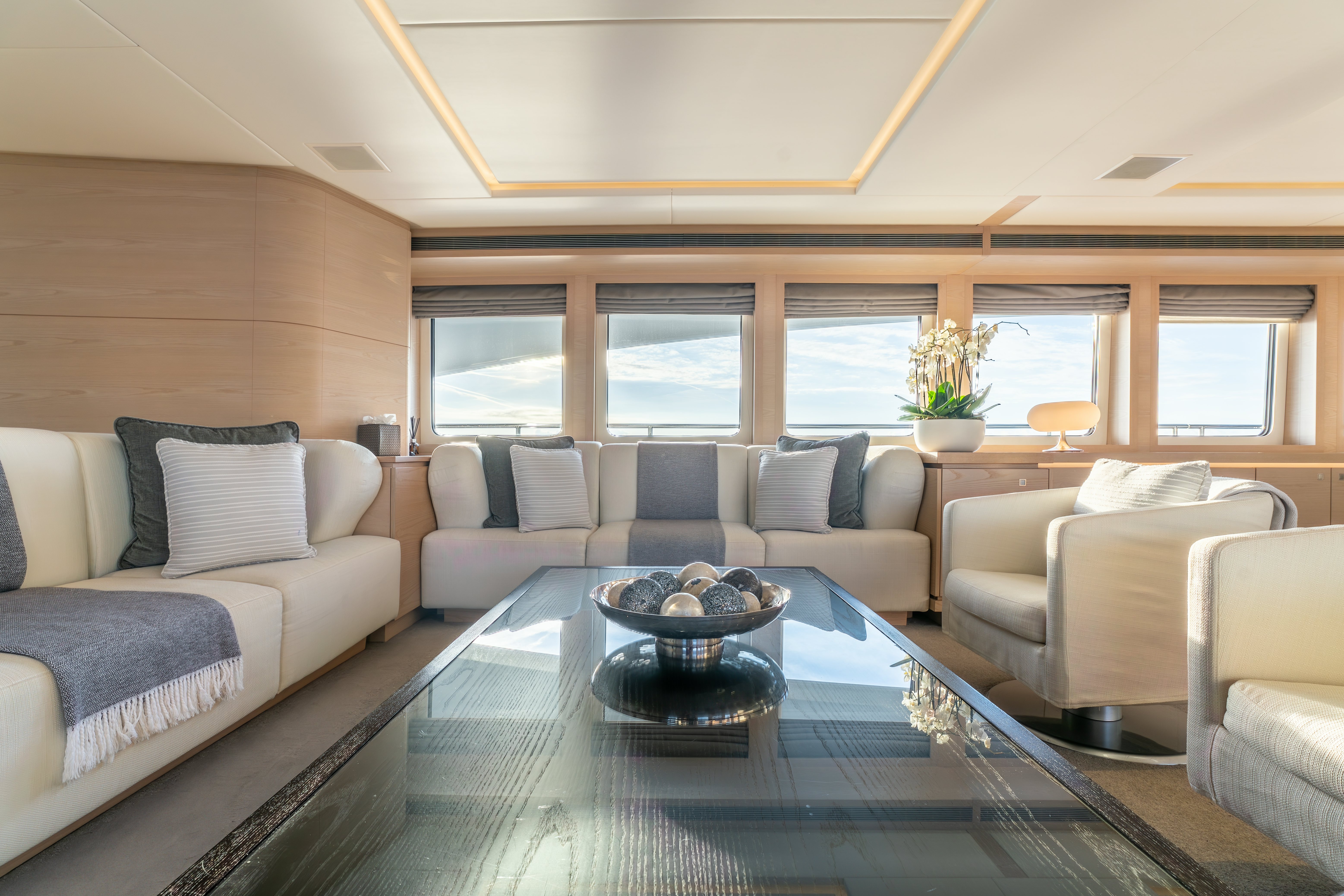 a living room with a table and couches aboard G3 Yacht for Sale