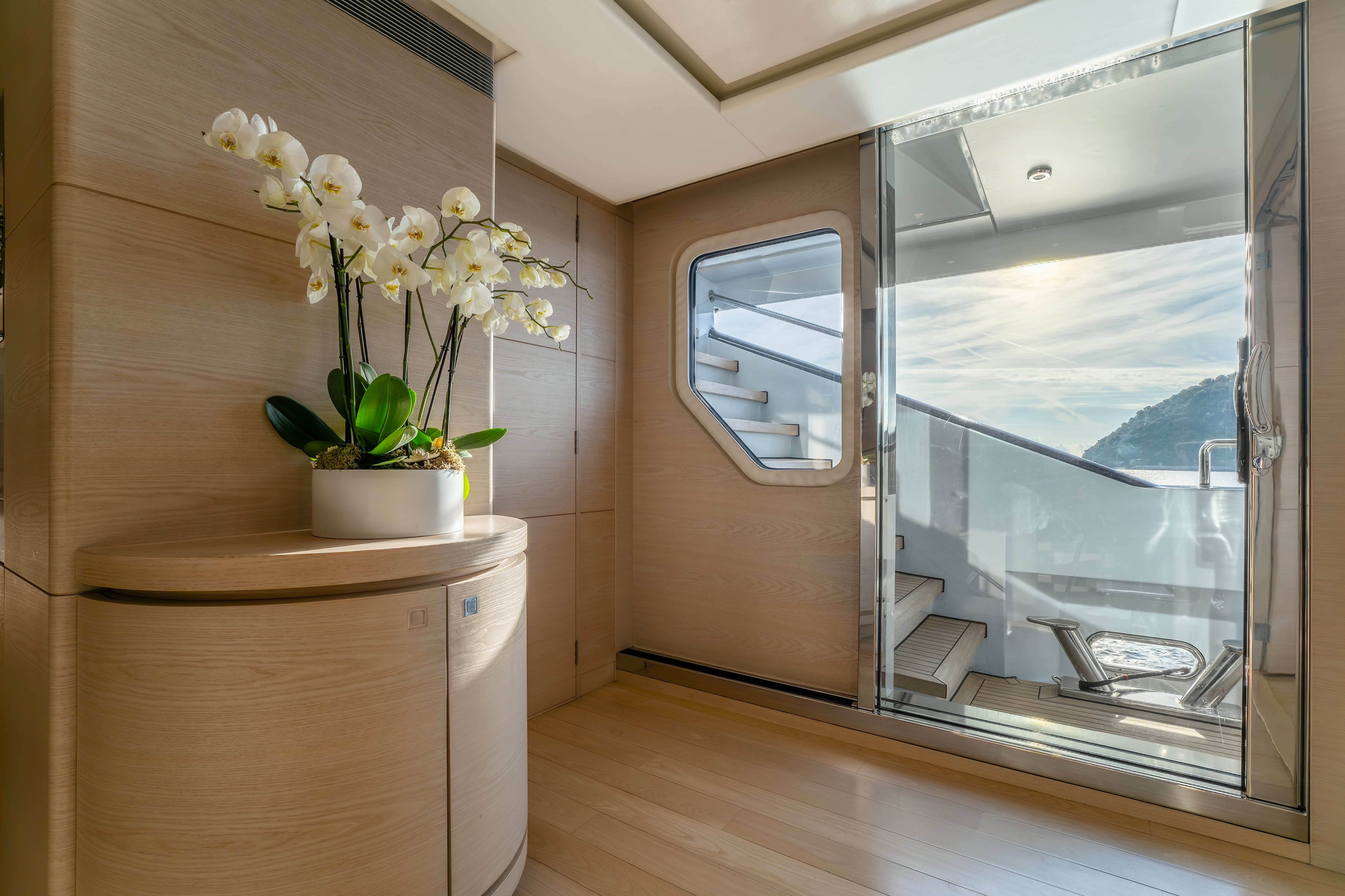a plant in a pot on a table in a room with a window aboard G3 Yacht for Sale