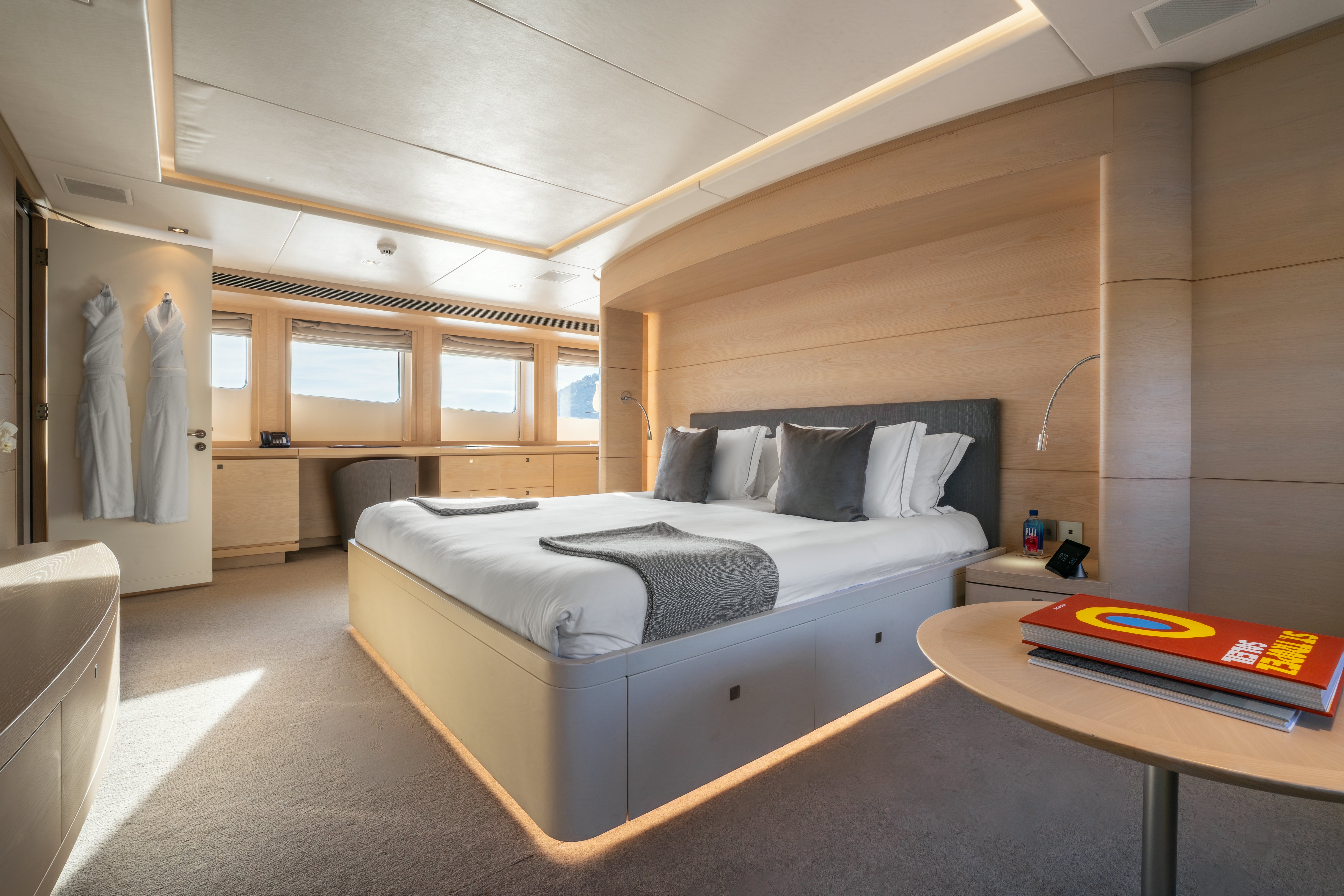 a bedroom with a bed and a desk aboard G3 Yacht for Sale