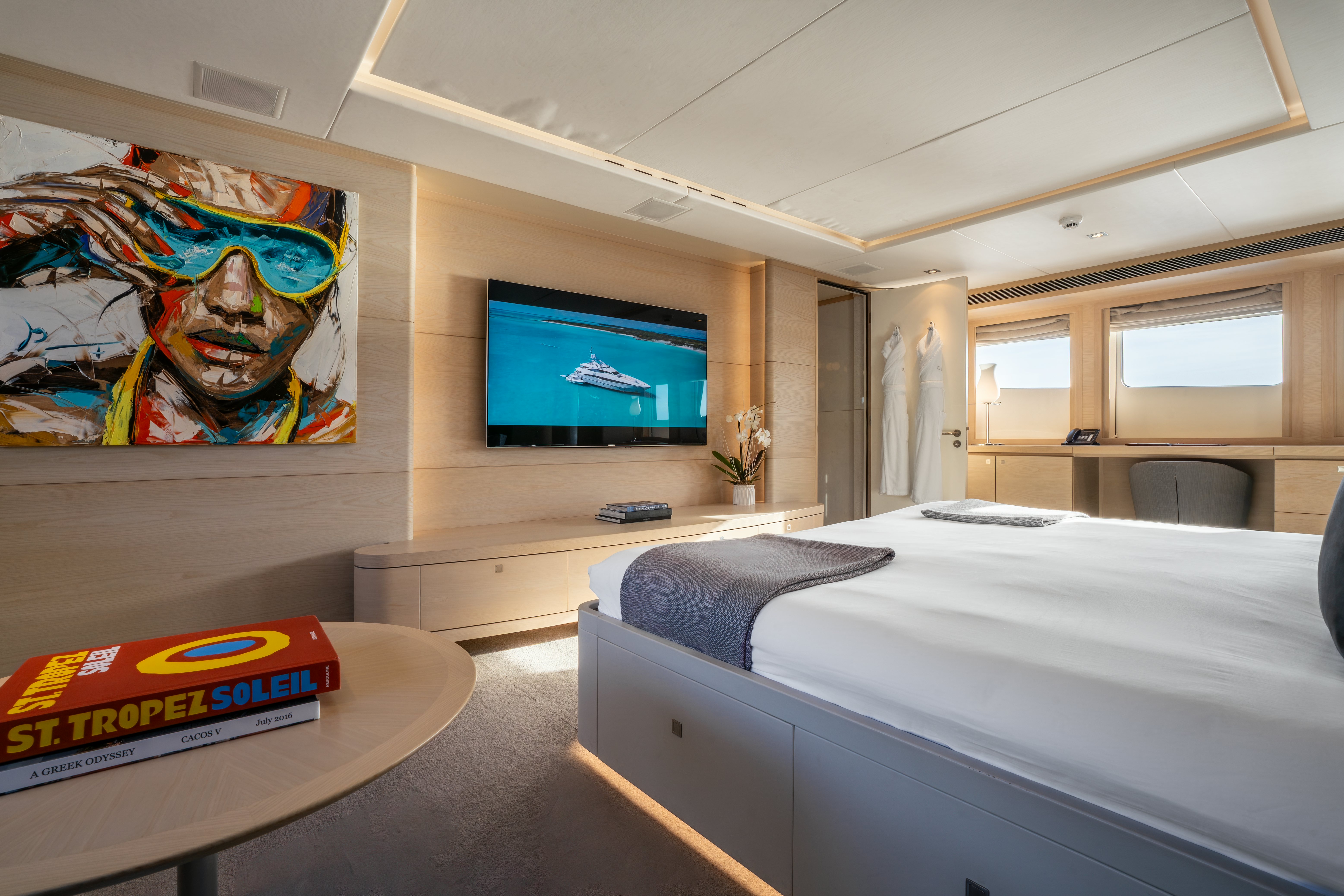 a bedroom with a tv and a bed aboard G3 Yacht for Sale