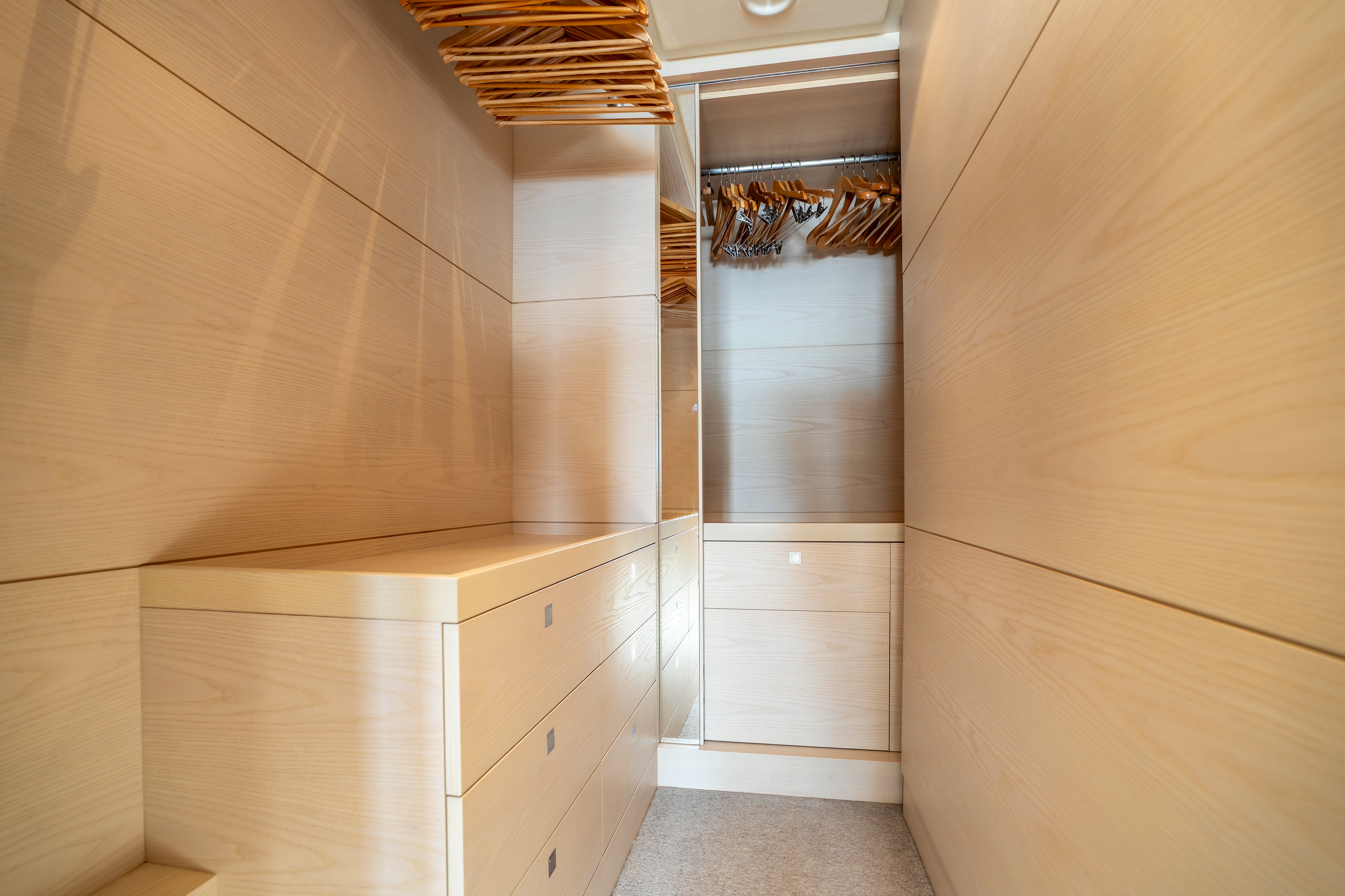 a room with a closet and a shelf with books on it aboard G3 Yacht for Sale