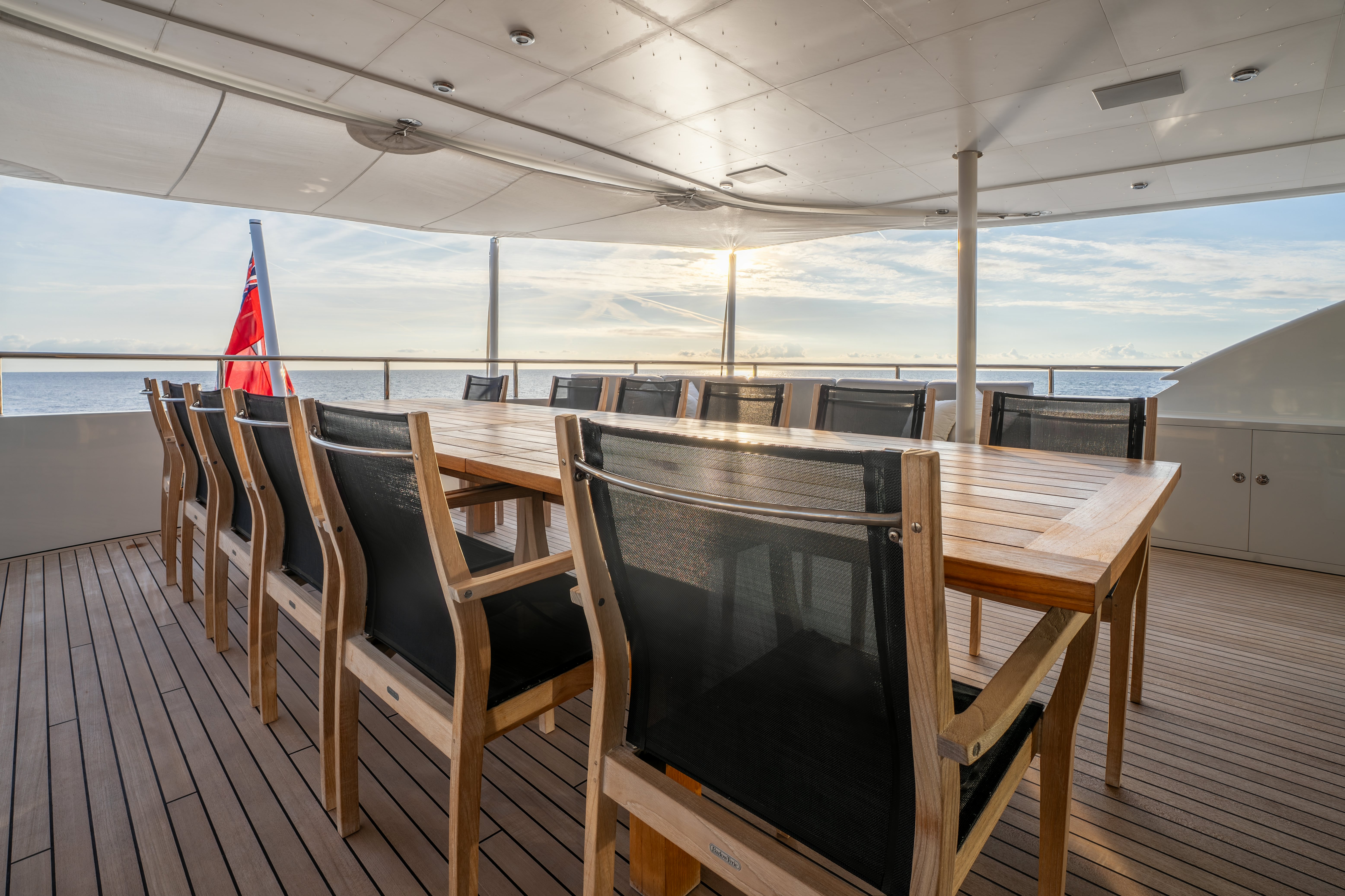 a wood table on a deck aboard G3 Yacht for Sale