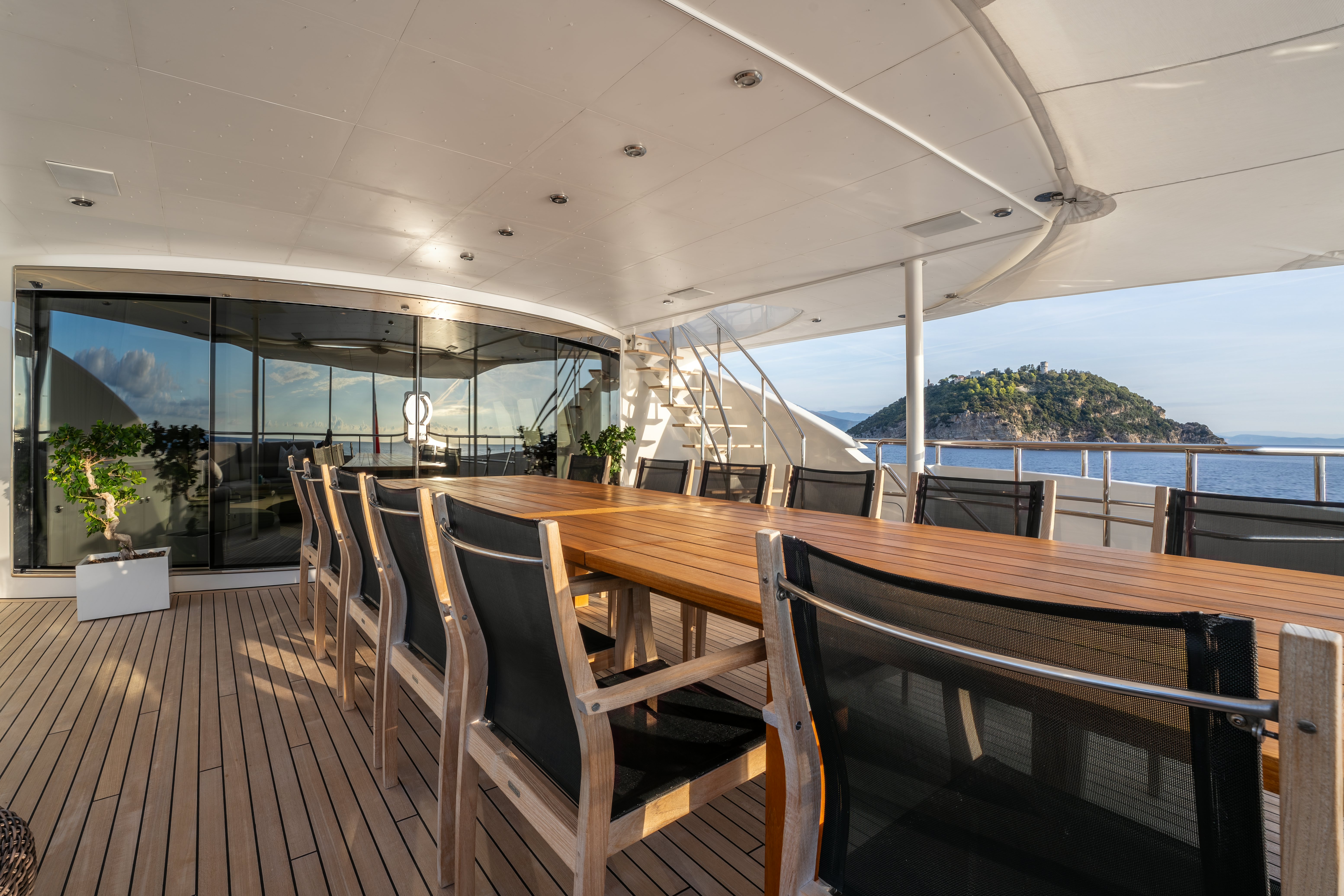 a wood deck with chairs on it aboard G3 Yacht for Sale