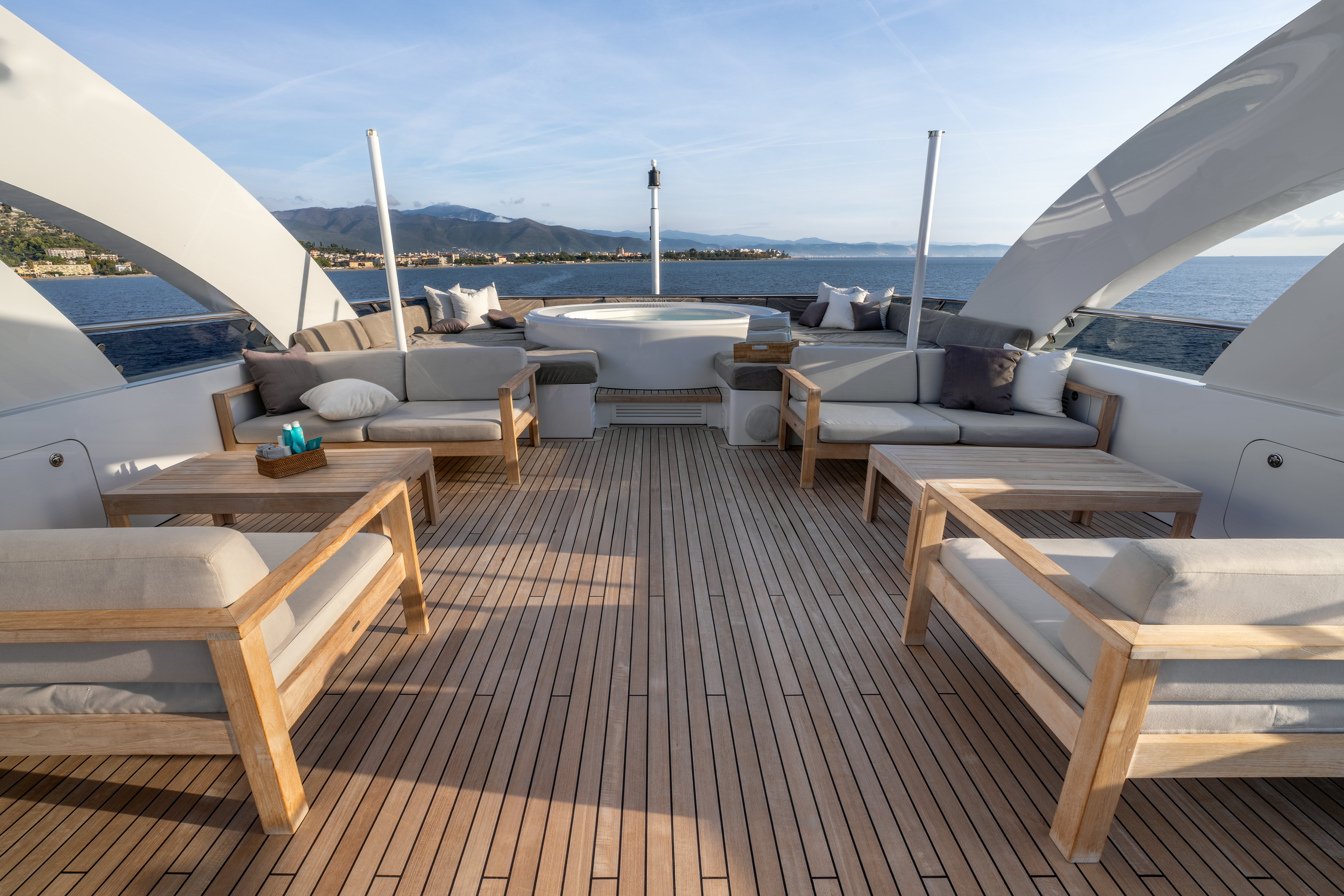 a deck with a view of the ocean and a large boat aboard G3 Yacht for Sale