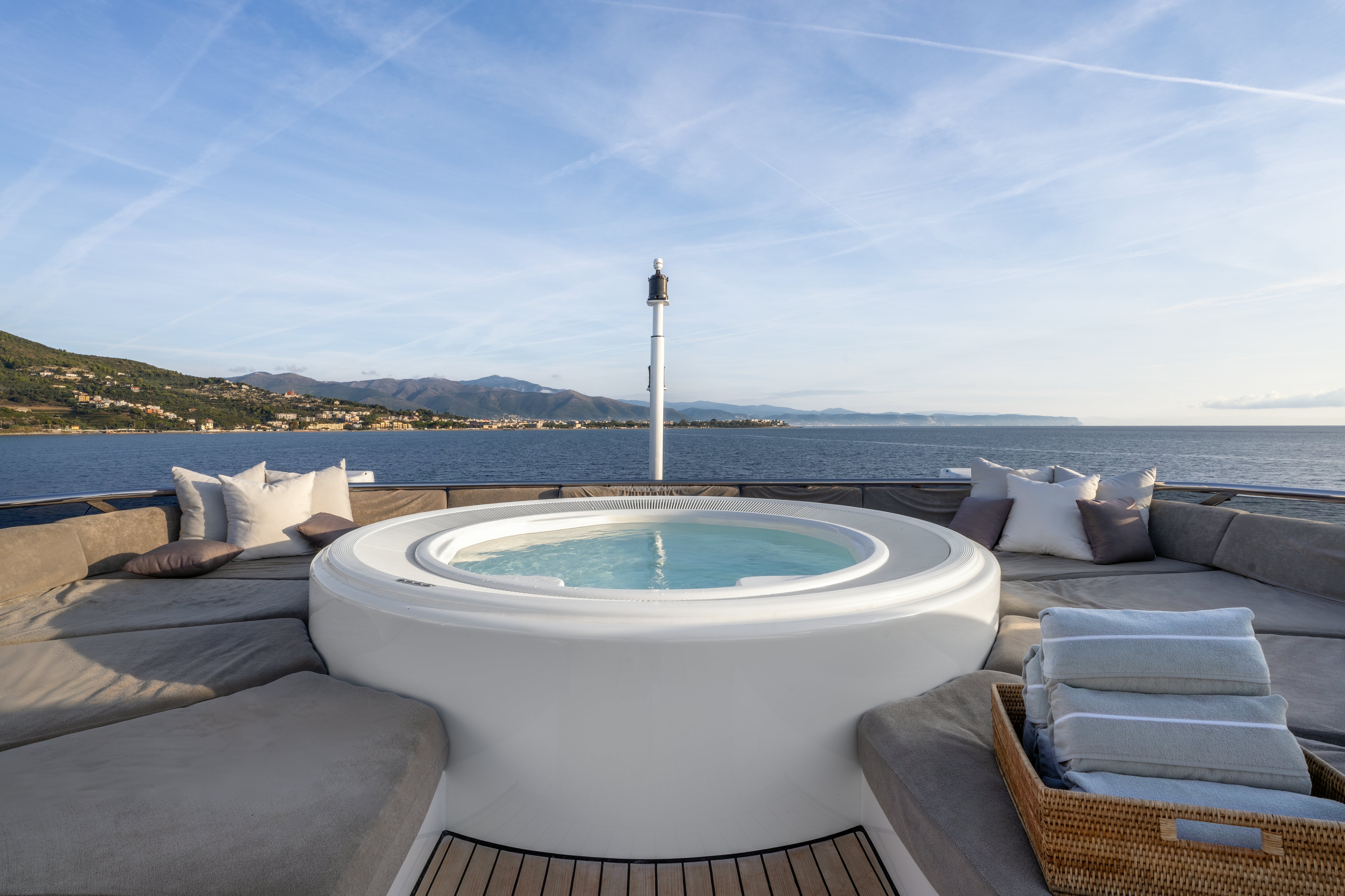 a large pool with a table and chairs by it aboard G3 Yacht for Sale
